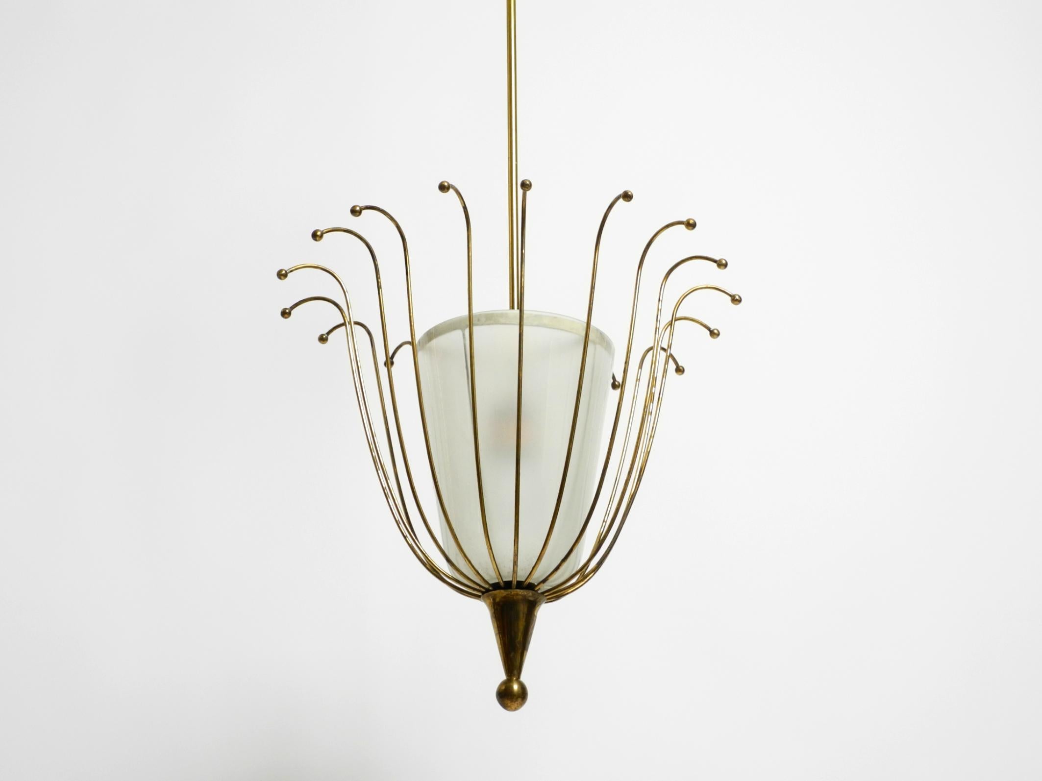 Beautiful large mid-century brass ceiling lamp.
The entire frame is made of solid brass. The lampshade is made of glass.
Typical elaborate Italian design of the 1950s.
Very good condition and fully functional. No damage to the entire lamp.
The shiny