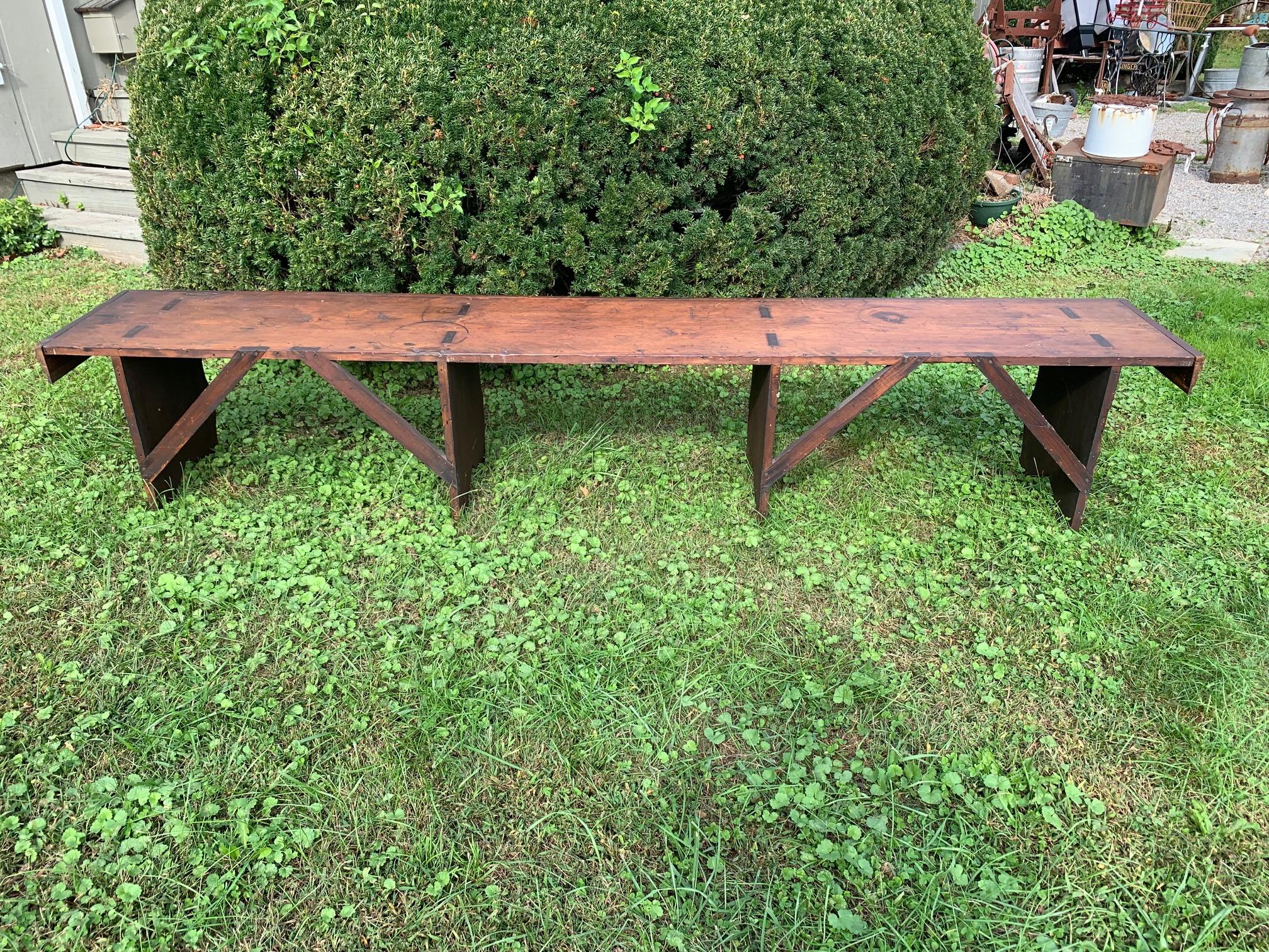 A rare especially long almost 9 foot gathering bench from rustic Pennsylvania, antique pine with wonderful patina. Was probably used outside of a church or general store. It is 8’ 9”.