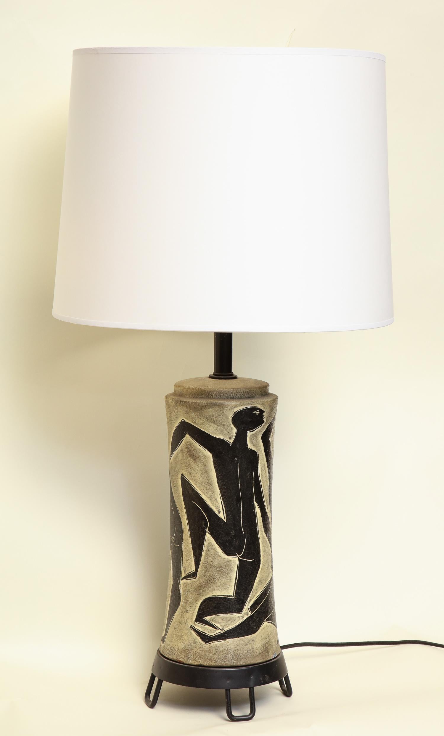 A table lamp signed Fantoni Italy ceramic with incised stylized Men iron base new sockets and rewired
Shade not included.