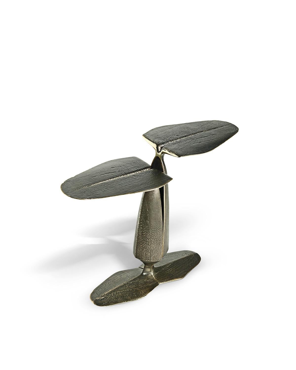 A brass cast sculptural side table enriched by a deep texture in an antique brushed finish. The organic leaf shaped top and branching structure offer a more dynamic take on classic silhouettes, departing from symmetry to create a unique
