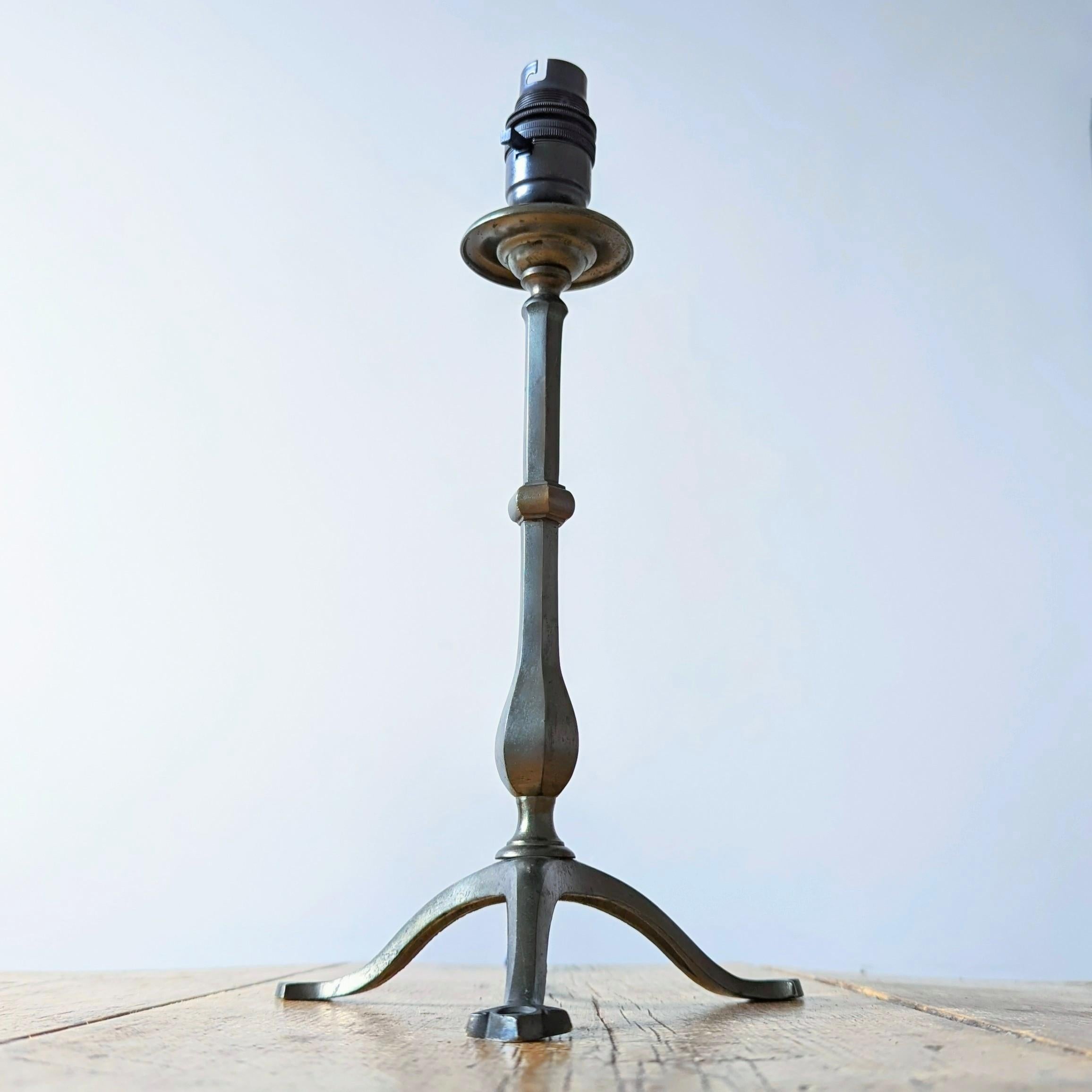 A smart silver plated brass pullman lamp attributed to Faraday & Son.

The crisp hexagonal stem is raised on three shapely legs.

Original hole in leg designed for wall attachment.

Excellent color and form.

Stamp likely covered by later
