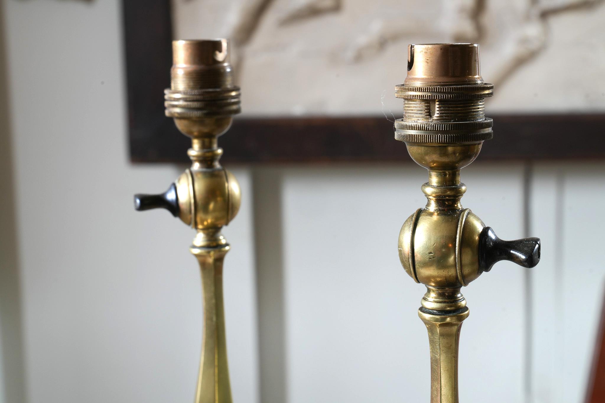A pair of tall polished brass table lights by Faraday & Son.

English, London, circa 1900.