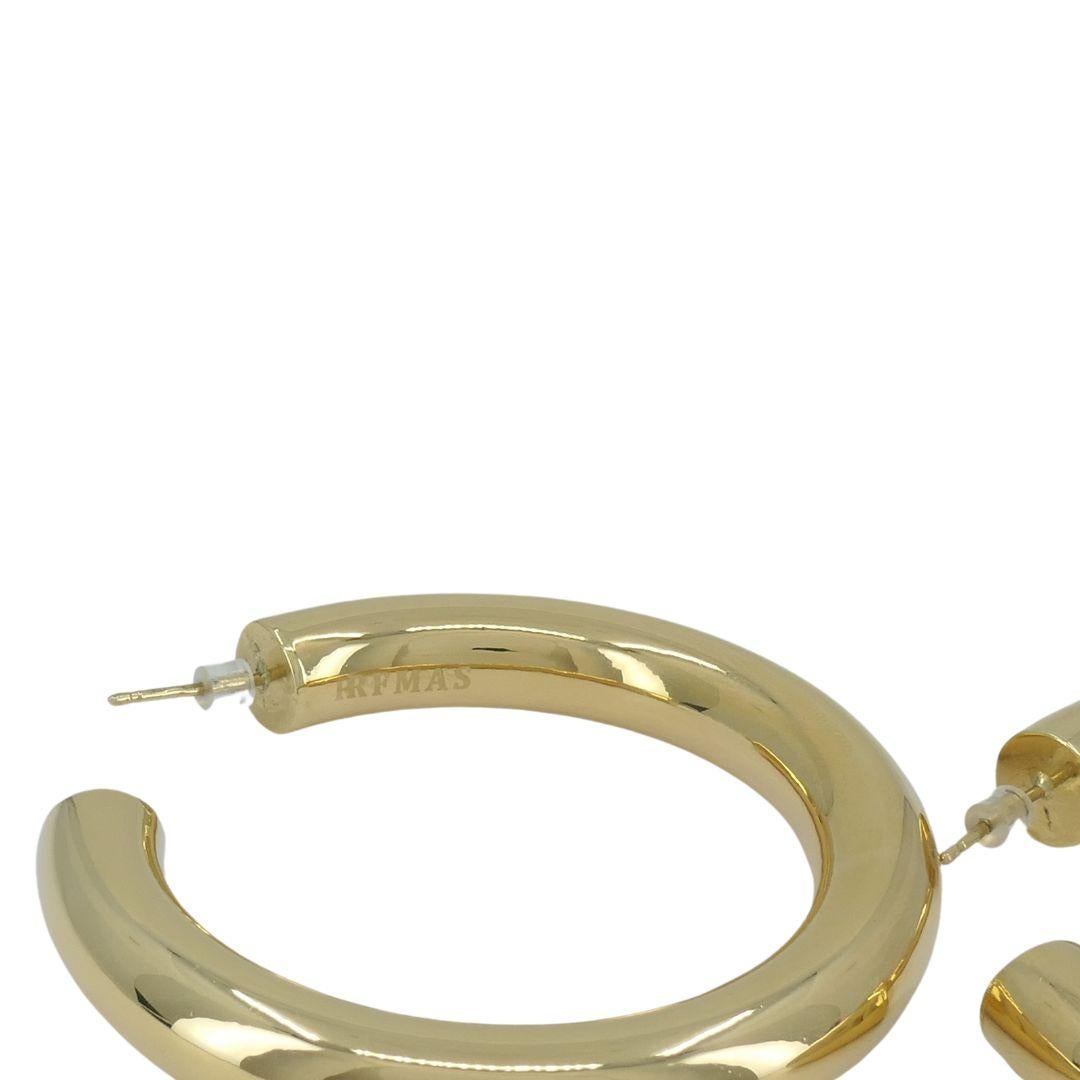 FARAONE MENNELLA by RFMAS 18k Gold Barabella Hoops
These bold hoops are 3/4 inch in diameter and weigh 25.3 grams, and are 8 millimeters in thickness. Meant for pierced ears, these hoops are hallow and won't feel heavy. They are signed RFMAS.