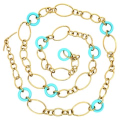 Faraone Mennella: collana lunga in oro 18 carati con maglie aperte, anello rotondo e pietre turchesi