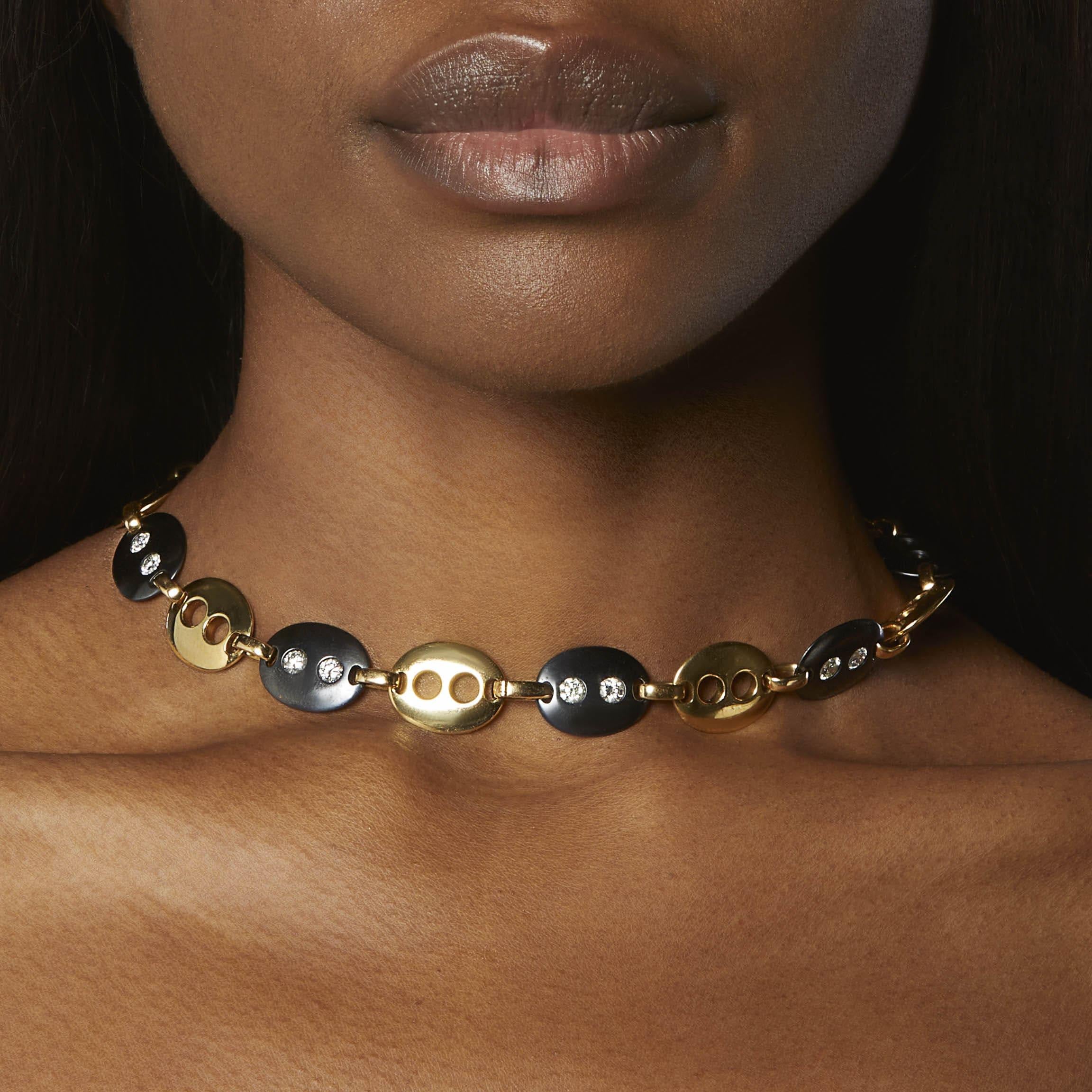 Created by New York-based Italian brand Faraone Mennella, this striking necklace of steel and gold converts into two bracelets. This elegant and unconventional necklace is designed as oval links of blackened steel, studded with brilliant-cut