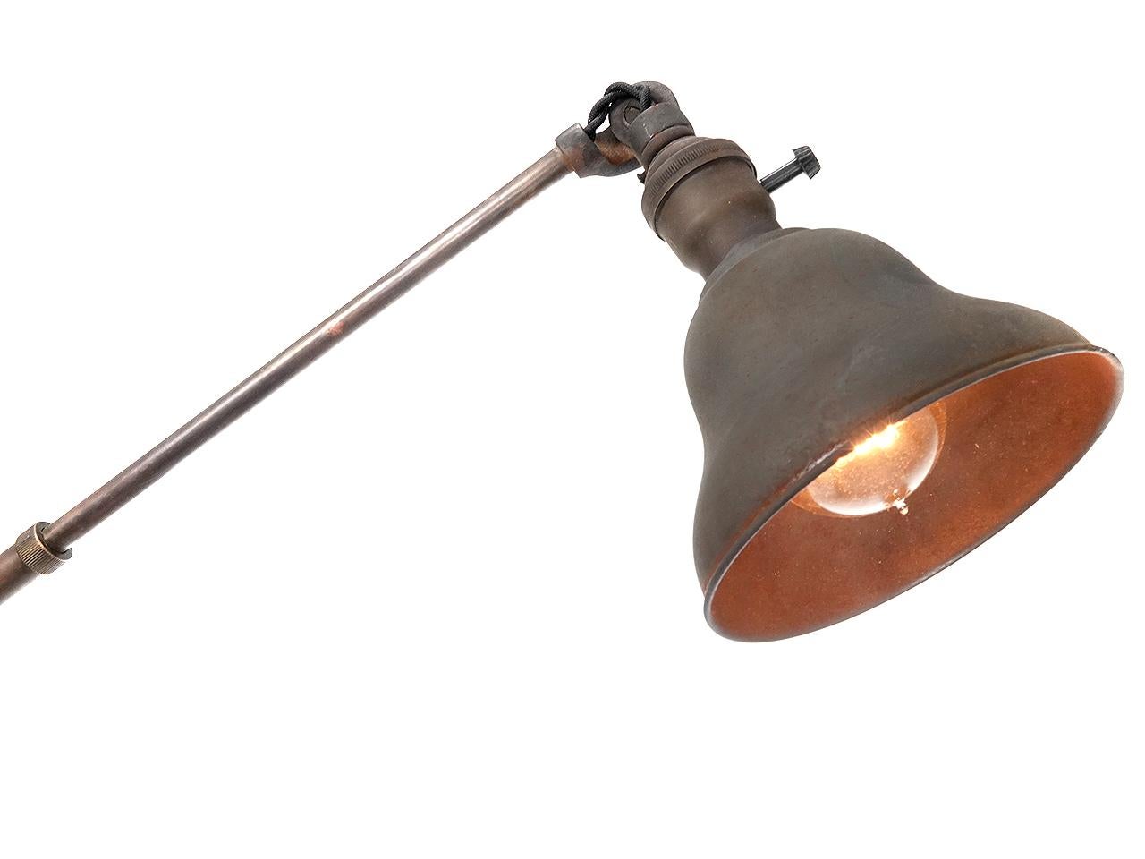 This original Faries lamp articulates, tilts and telescopes. The patina and parts are all original but it has been rewired. It can clamp to a desk or a pipe.