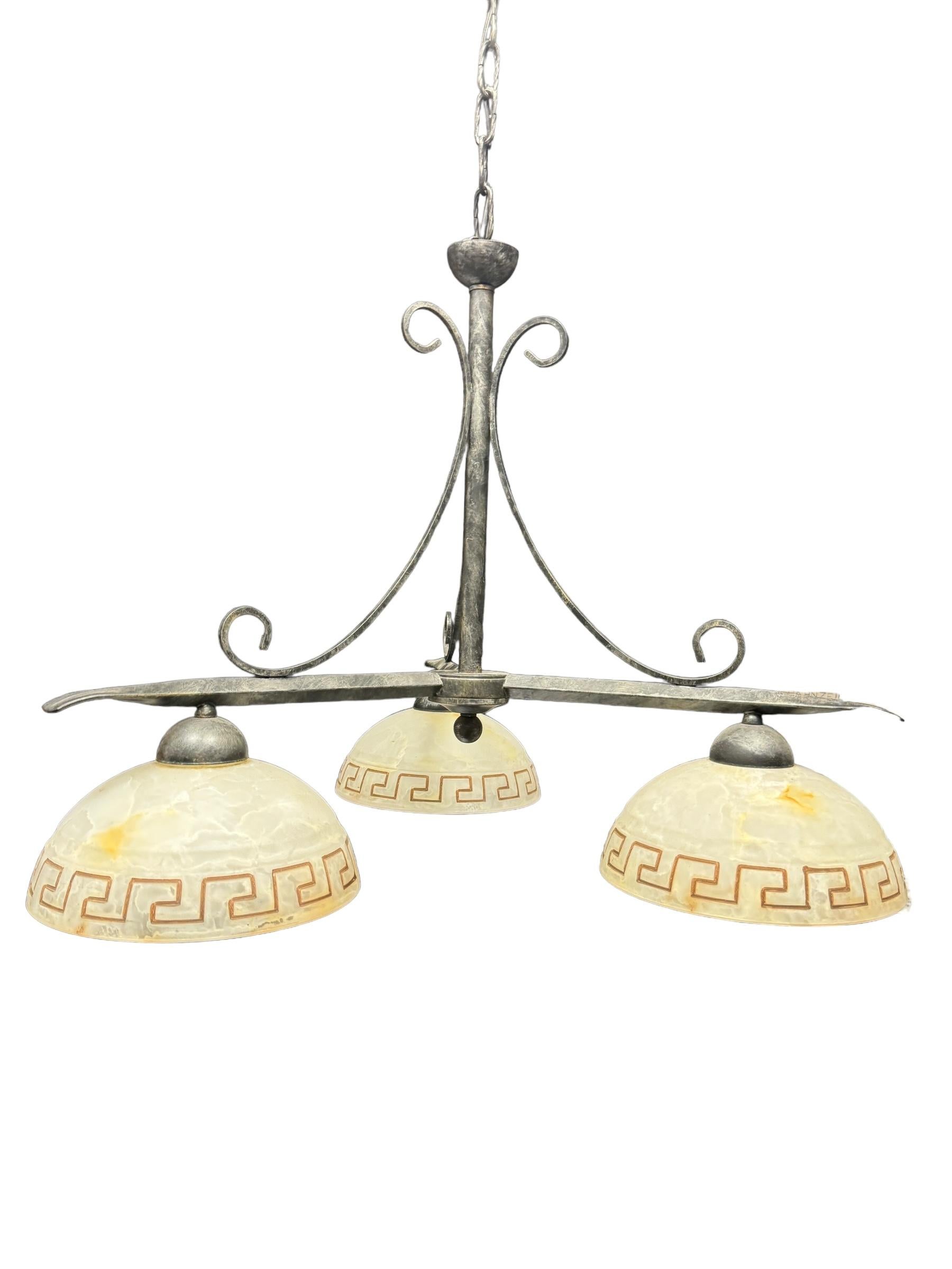 Add a touch of opulence to your home with this charming Chandelier. Perfect colored metal frame with glass shades to enhance any chic or eclectic home. We'd love to see it hanging in an entryway or dining room as a charming welcome home. Built in