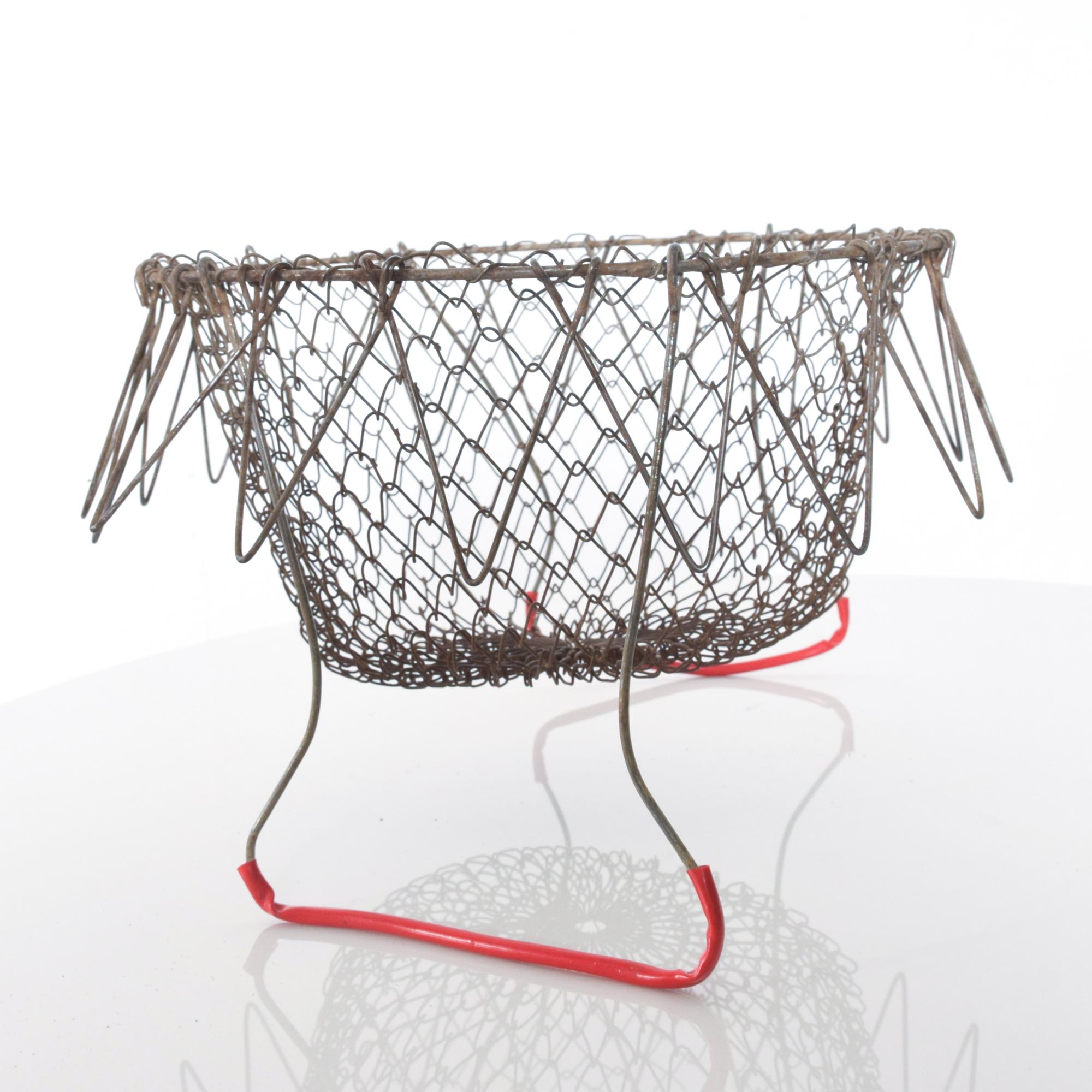 Collapsible red handled antique egg basket wire carryall intricate pattern 
mesh grid
Perfect for egg collecting or as a decorative accessory.
Measures: 8 1/2