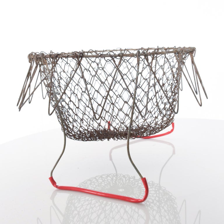 Collapsible red handled antique egg basket wire carryall in intricate patterned mesh grid
Perfect for egg collecting or as a decorative accessory.
Measures: 8 1/2