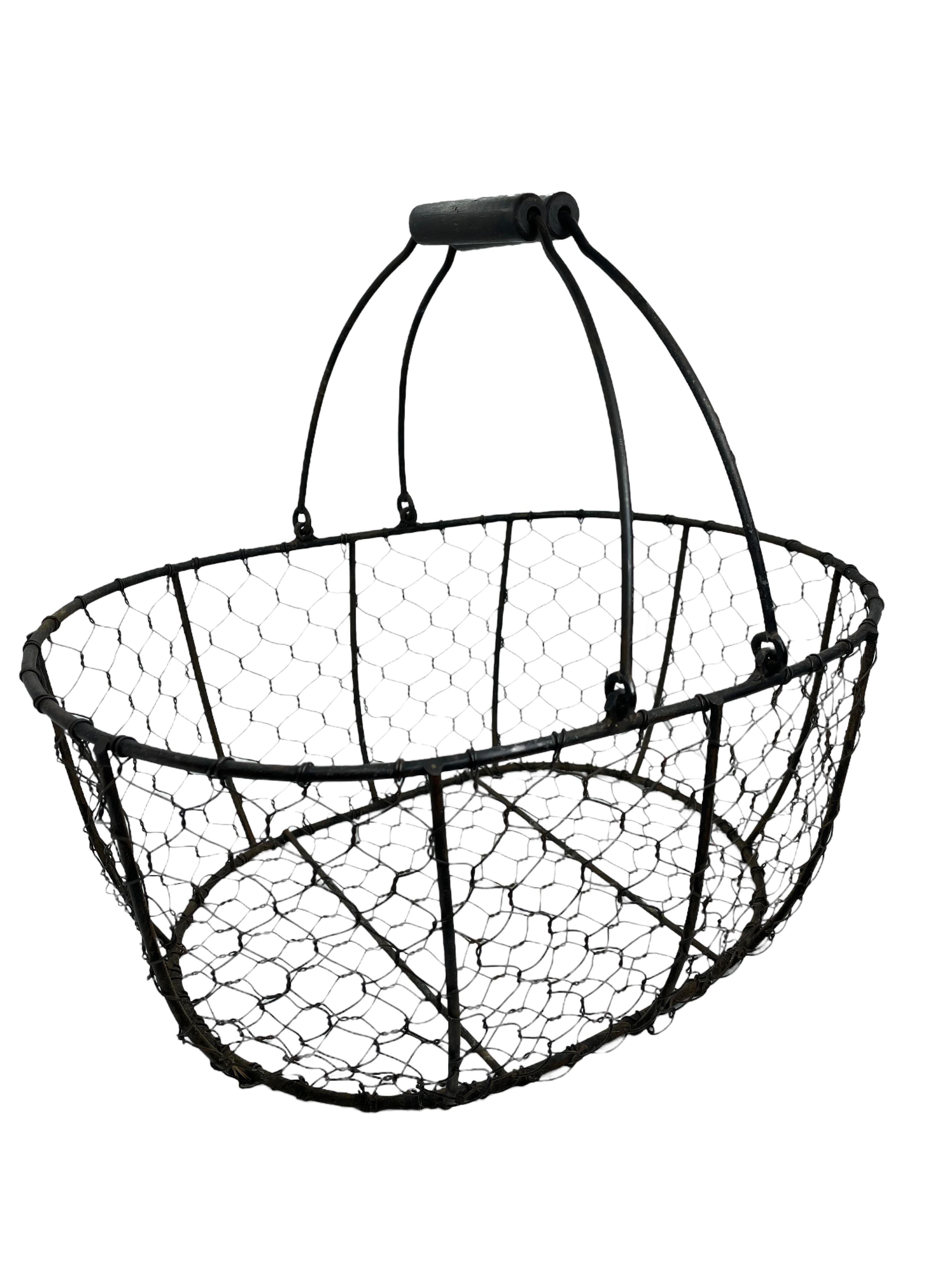 Beautiful chicken wire made Basket, circa 1930s. Made of wire and wooden handles. Found at an estate sale in Vienna, Austria. Nice addition to any Country Kitchen. Size given in measurements section is from the ground to the end of the handles.
