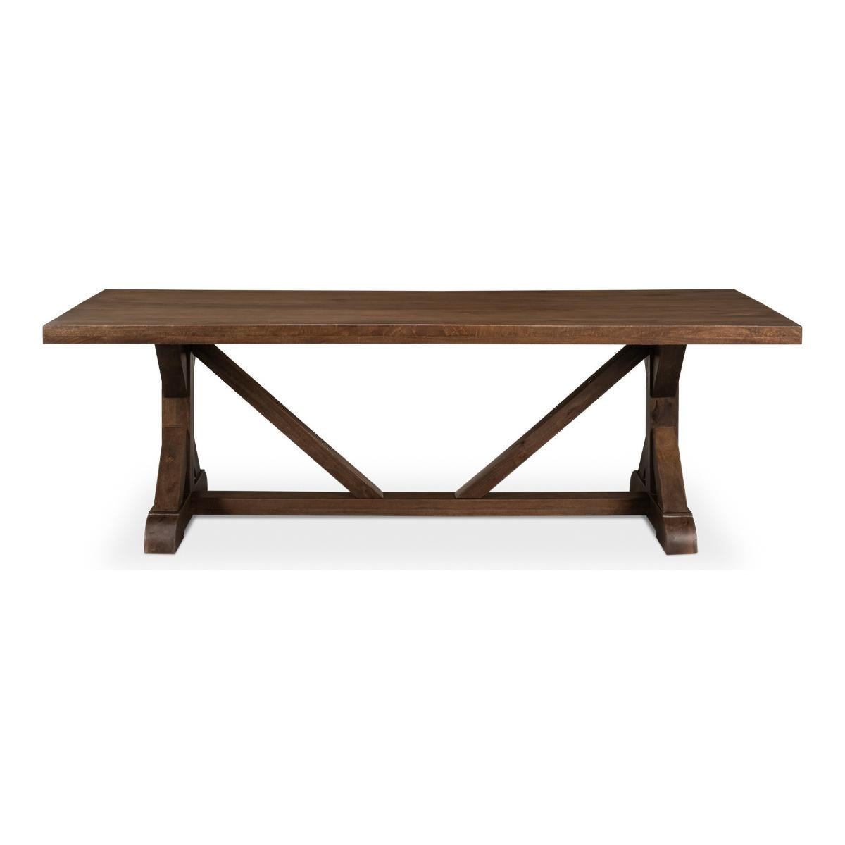 Farmhouse Refectory dining table is constructed of reclaimed wood in a walnut finish, with trestle end supports and a stretcher base.

Dimensions: 95