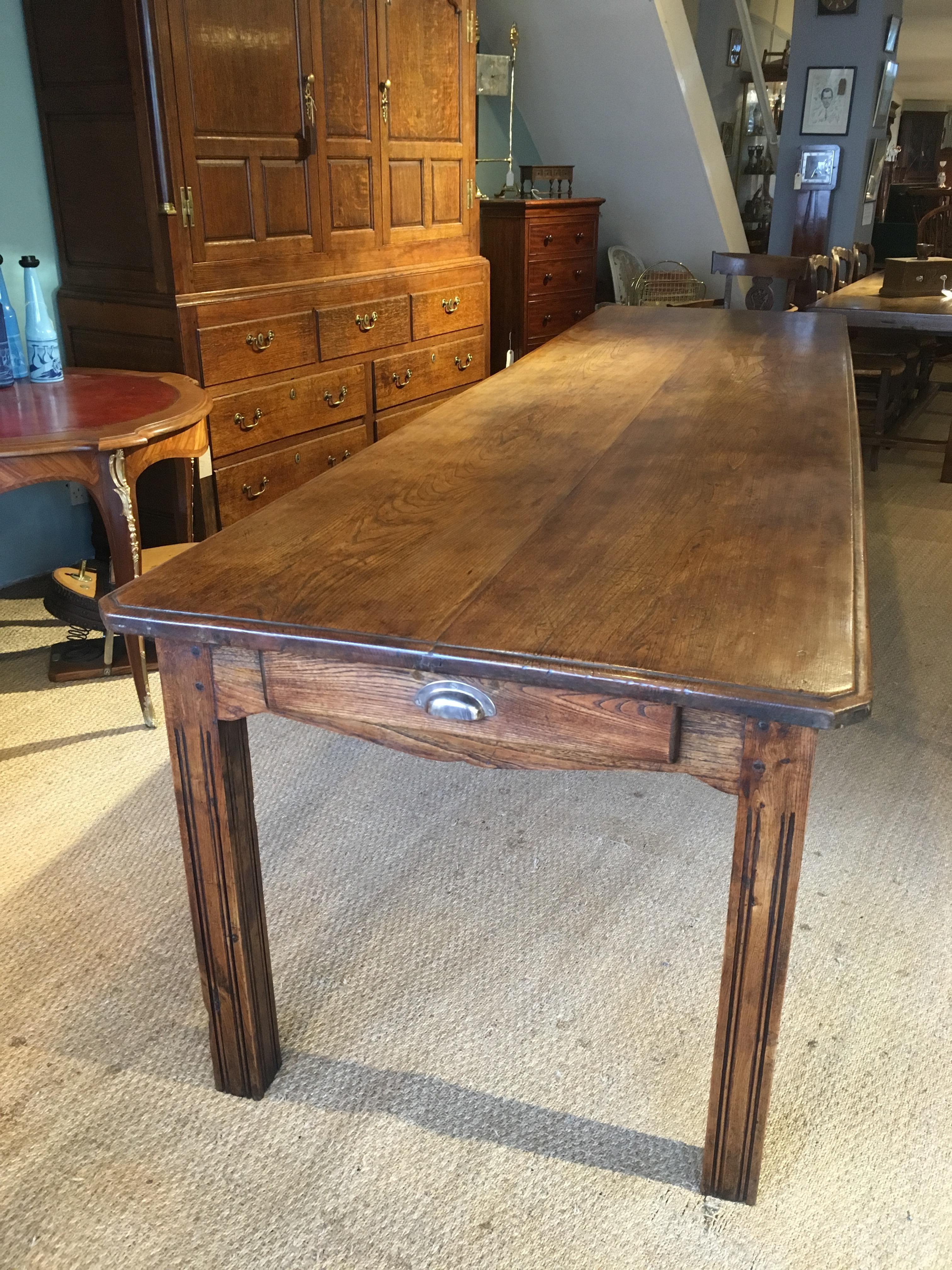 Fabulous Early 20th century Elm farmhouse table, 3.35 meters long.

Dating to around the 1920 and constructed from solid Elm , single drawer to each end , 2 plank top a real statement piece , will seat 12-14 people 

The beauty of this table is