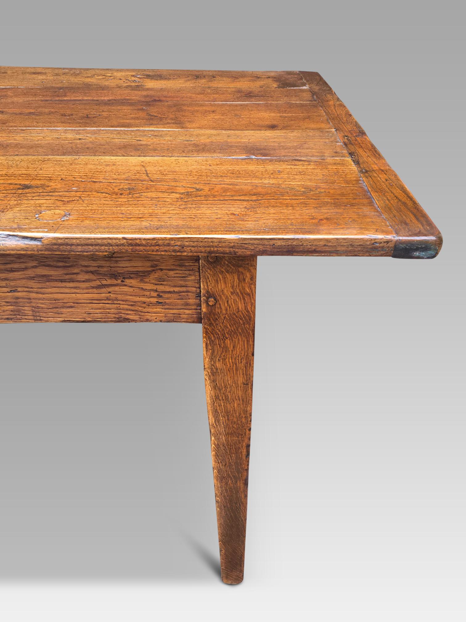 Good family size farmhouse Elm table, circa 1880 measuring 9 ft long by 3 ft. wide. 
This farmhouse table stands on robust tapered legs, has 2 end drawers and a top with a generous overhang.
The table top is flat and level with a warm mid oak colour