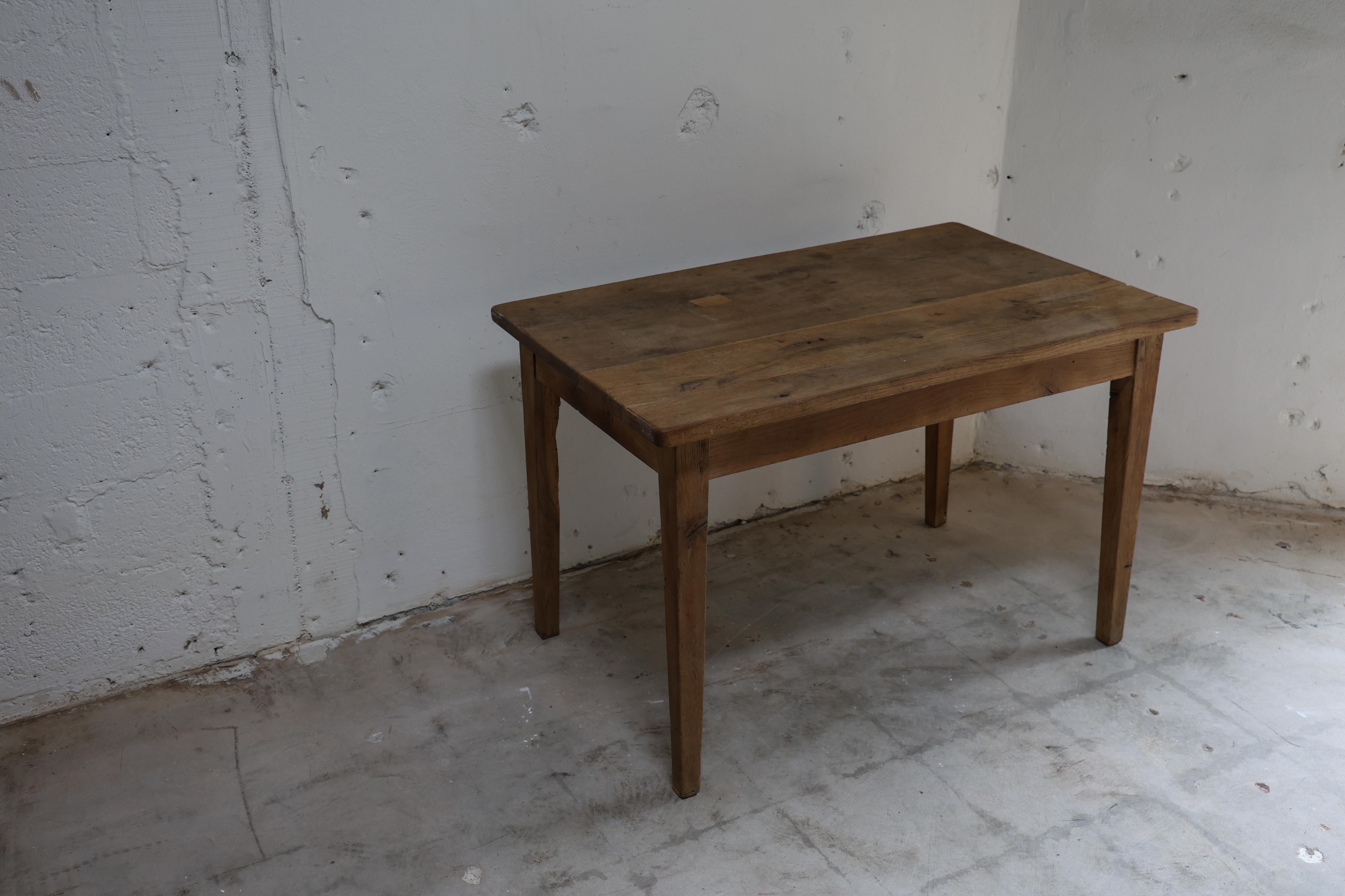 Rooted in the traditions of rural France, this farm table carries the quiet authenticity of everyday craftsmanship. Constructed from solid hardwood, its plank top bears a rich patina developed through generations of use—subtle wear, surface marks,