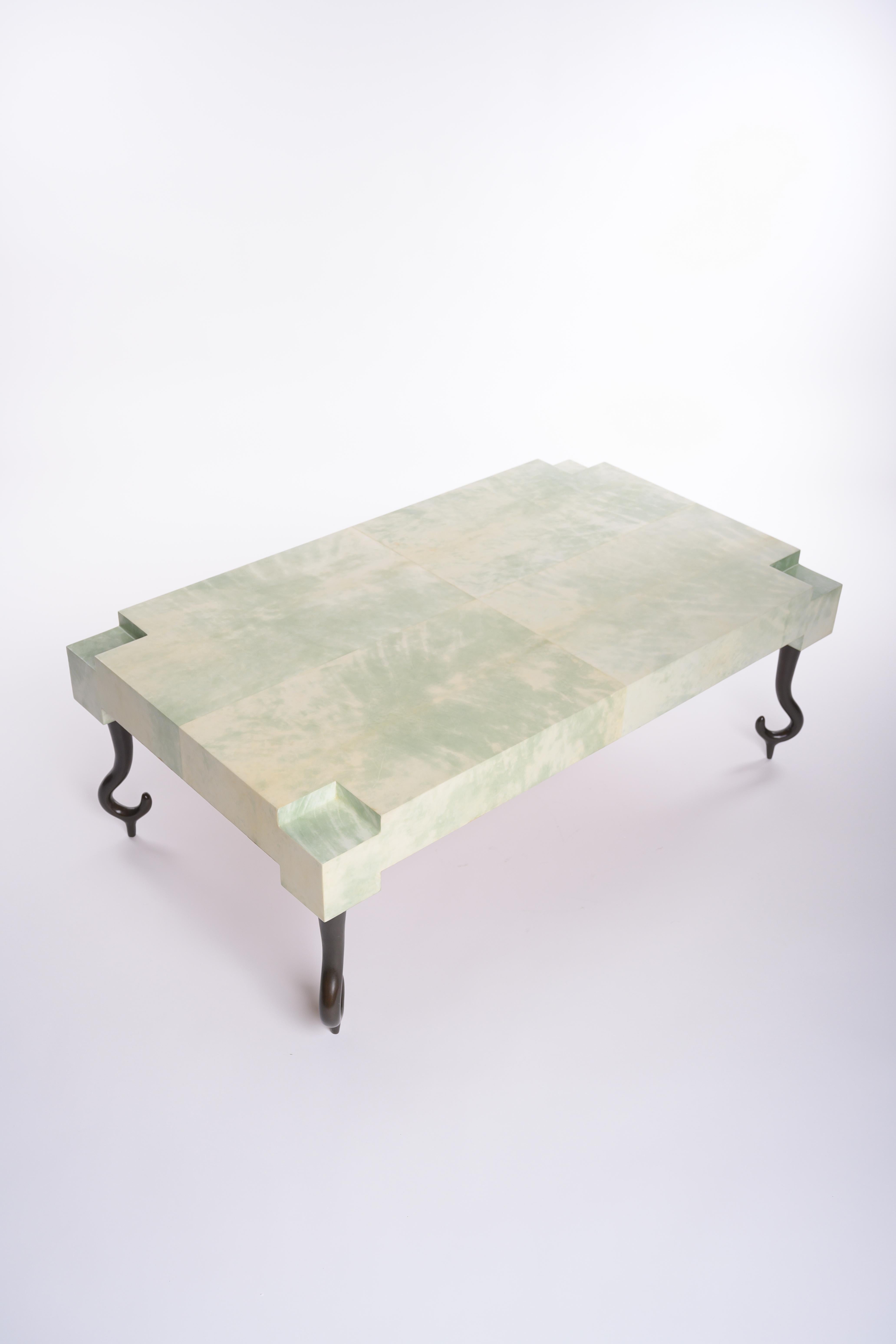 Faroh Coffee Table in Parchment and Cast Bronze by Elan Atelier

The distinctive Faroh coffee table features an elegant geometric top form wrapped in luxurious dyed parchment on cast bronze legs. Shown here in our Jade Parchment finish. Custom sizes