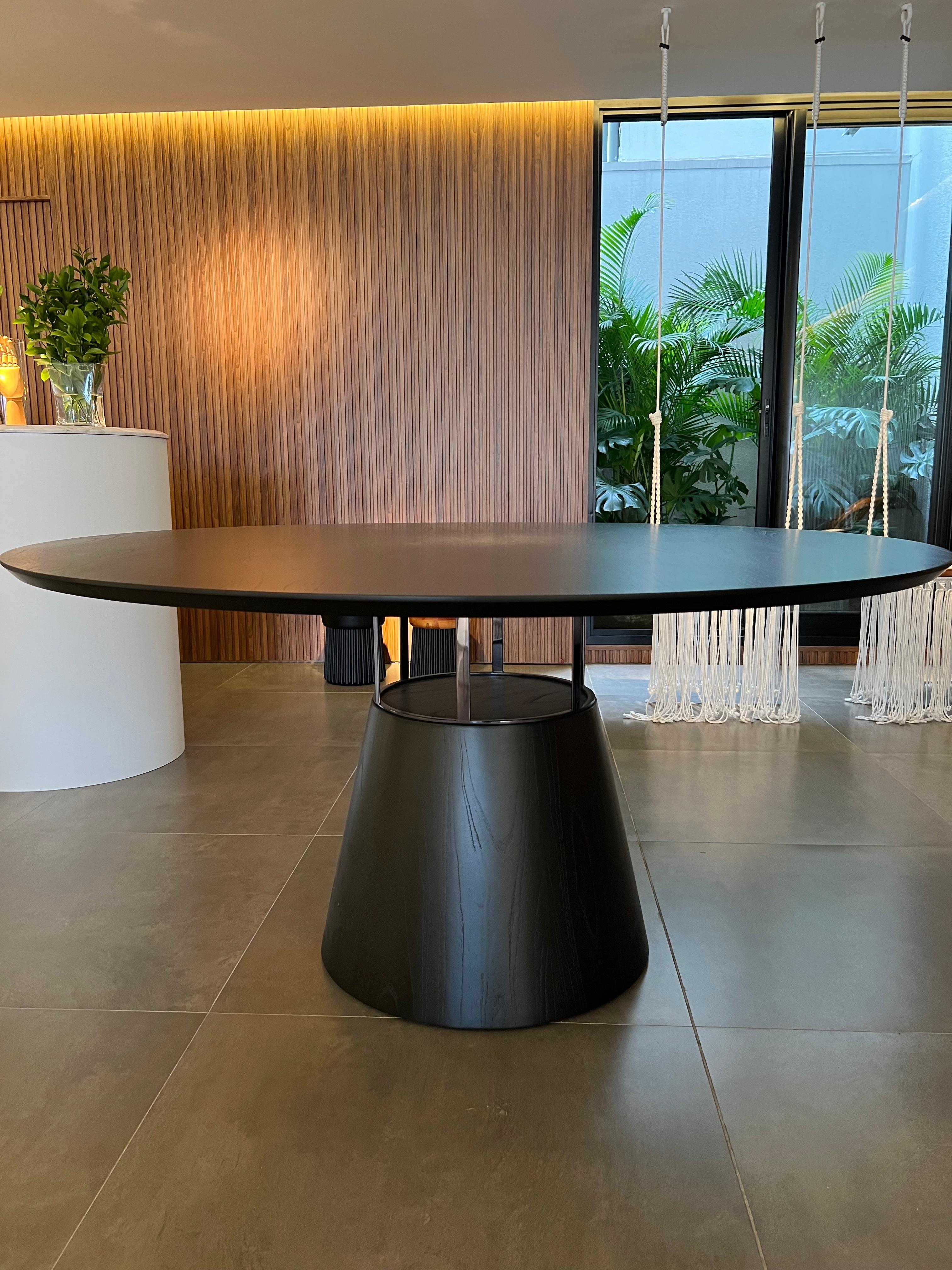 Elegante tavolo da pranzo dal design contemporaneo.
Il tavolo da pranzo rotondo Farol ha una base a forma di cono, realizzata in fibra di vetro rivestita con impiallacciatura in legno naturale di colore nero. I dettagli sono in metallo, acciaio al