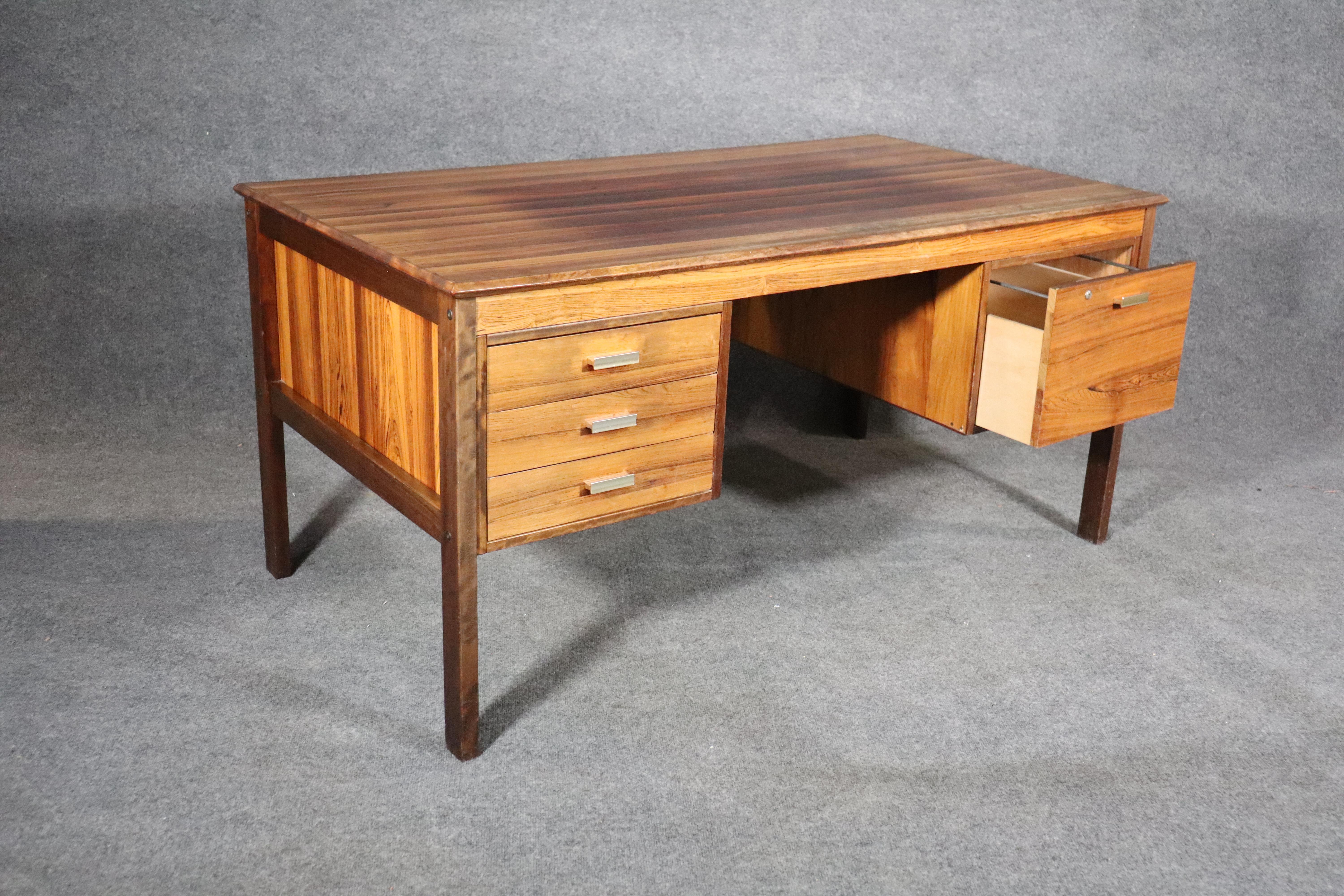 Stunning rosewood desk made by Farsø Stolefabrik For Maurice Villency. Deep wood grain throughout with accenting metal pulls, and finished back.
Please confirm location.