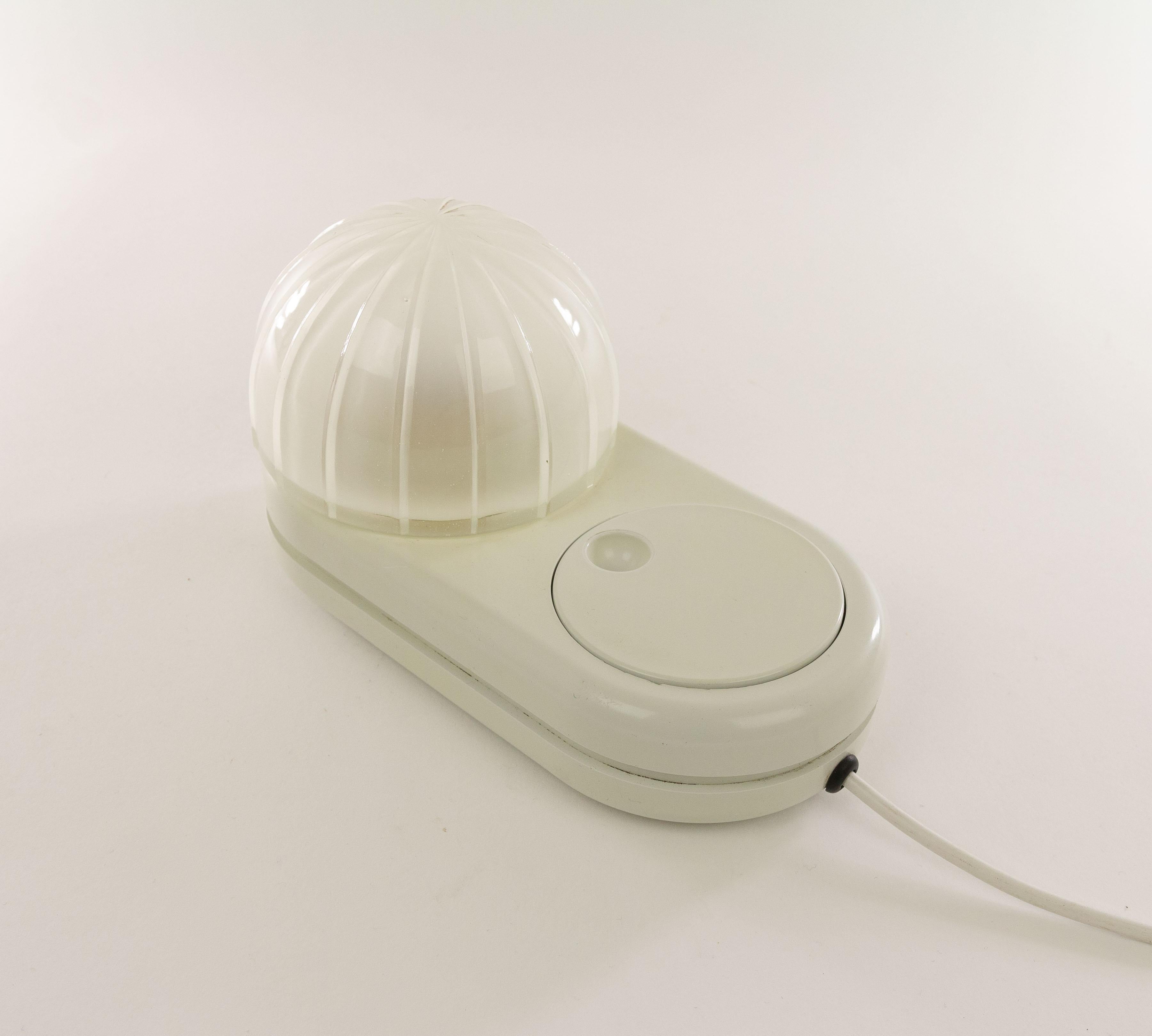 White Farstar table lamp designed by Adalberto Dal Lago (1973) and manufactured by Bieffeplast.

The dome shaped glass shade sits on a plastic base. The large round light dimmer that also functions as an on / off switch is a characteristic feature