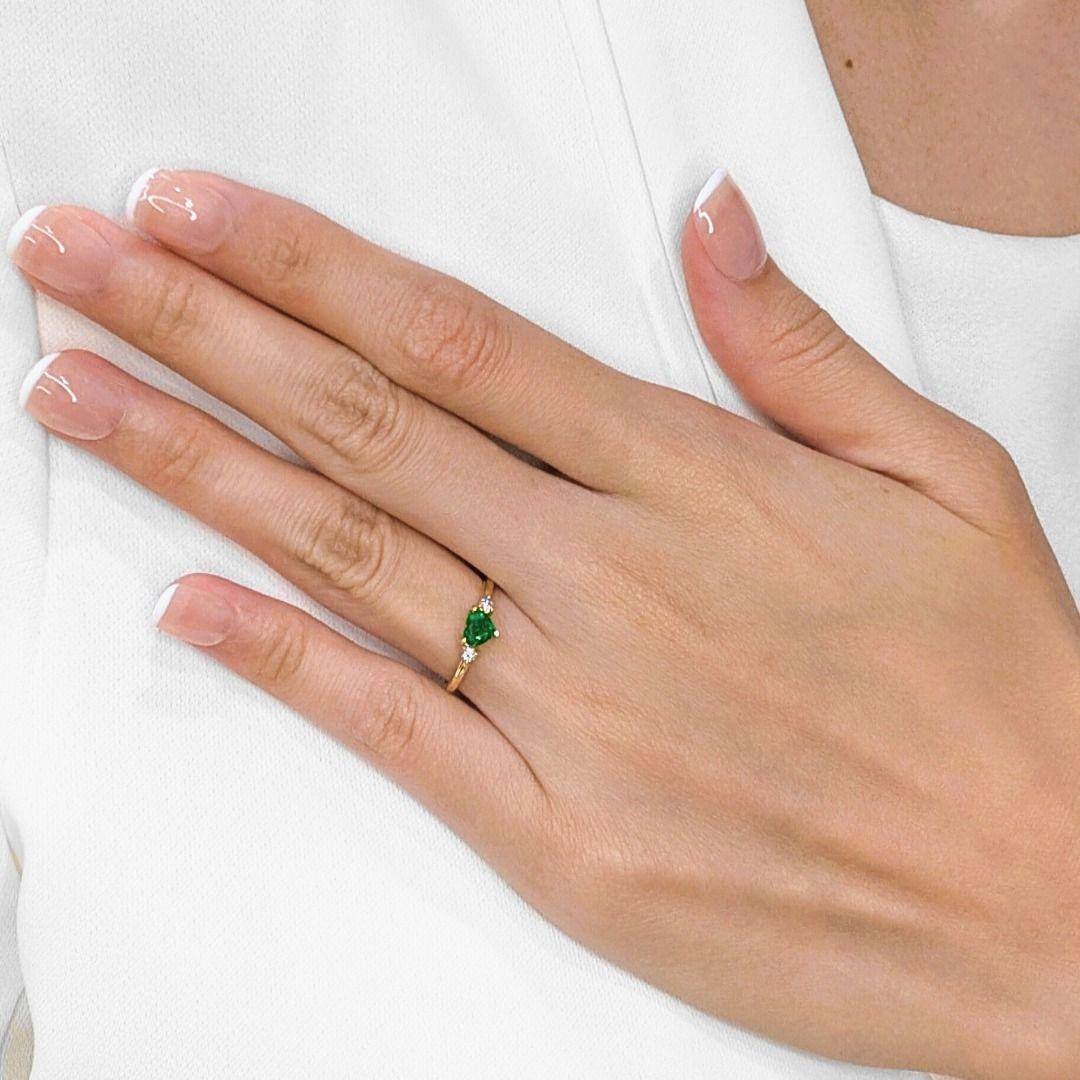 Imagine a ring that whispers tales of enduring love and vibrant beauty! This exquisite new ring, crafted from warm 18K yellow gold, truly captures the essence of romance. At its very core, a captivating 0.40ct natural emerald, perfectly shaped into