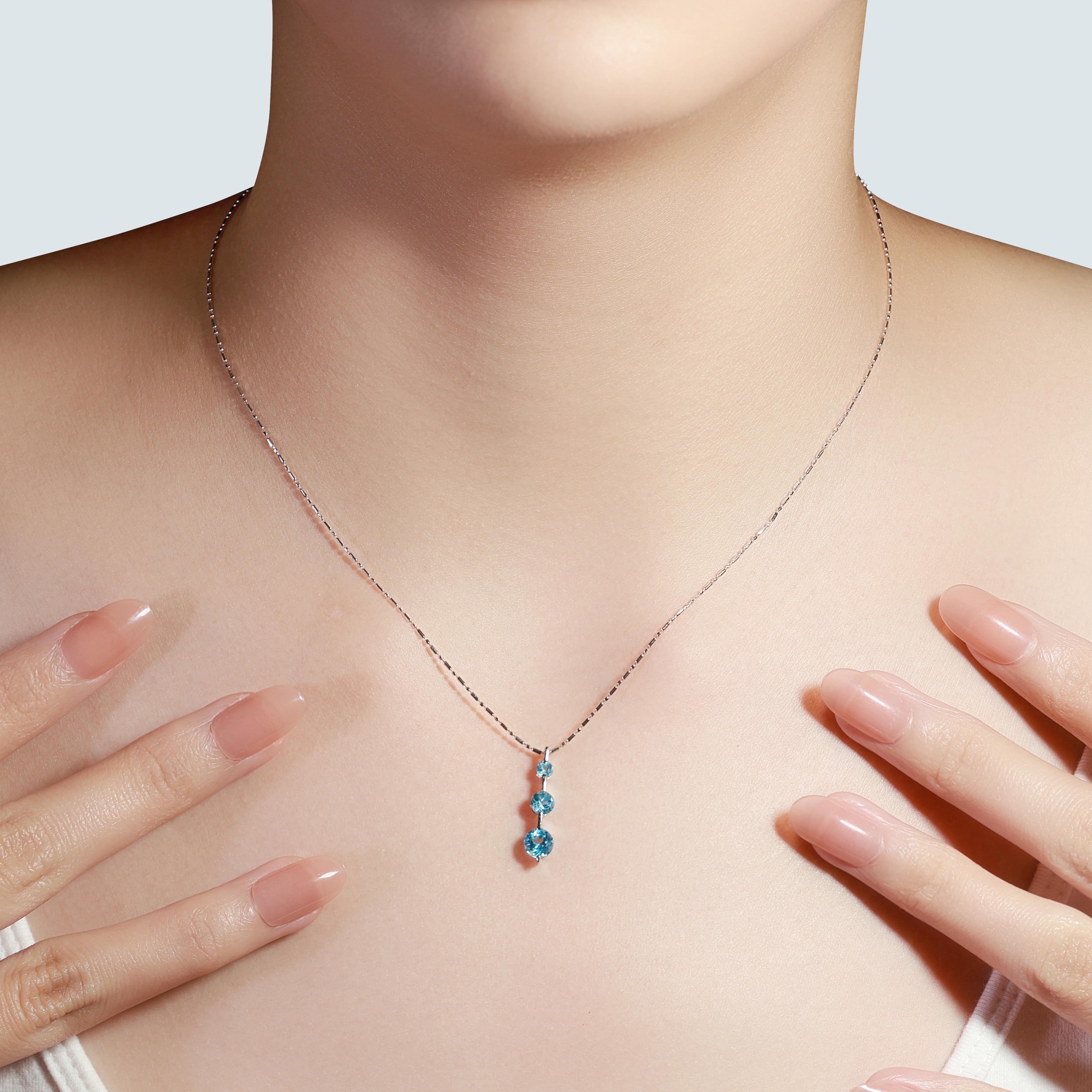 Experience the mesmerizing allure of this elegant piece, crafted from 18K white gold. Featuring three stunning round brilliant topaz stones, with a total carat weight of 1.6ct, each stone radiates a light blue hue that captivates the eye. Weighing a