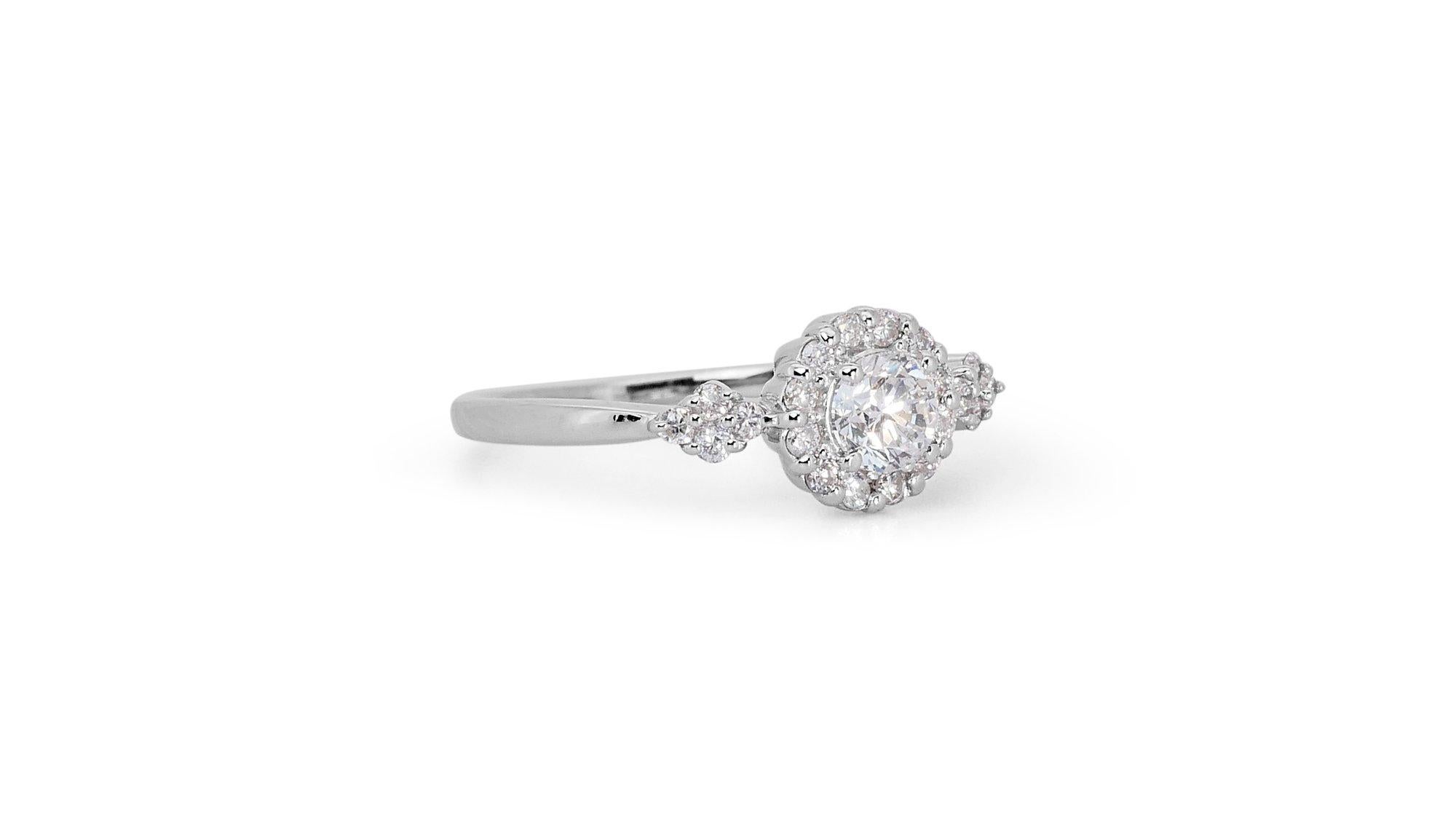 Fascinating 18k White Gold Natural Diamond Halo Ring w/0.72 ct - GIA Certified

Introducing this fascinating diamond halo ring that embodies timeless elegance and brilliance. Featuring a stunning 0.70 carat round diamond center stone nestled within