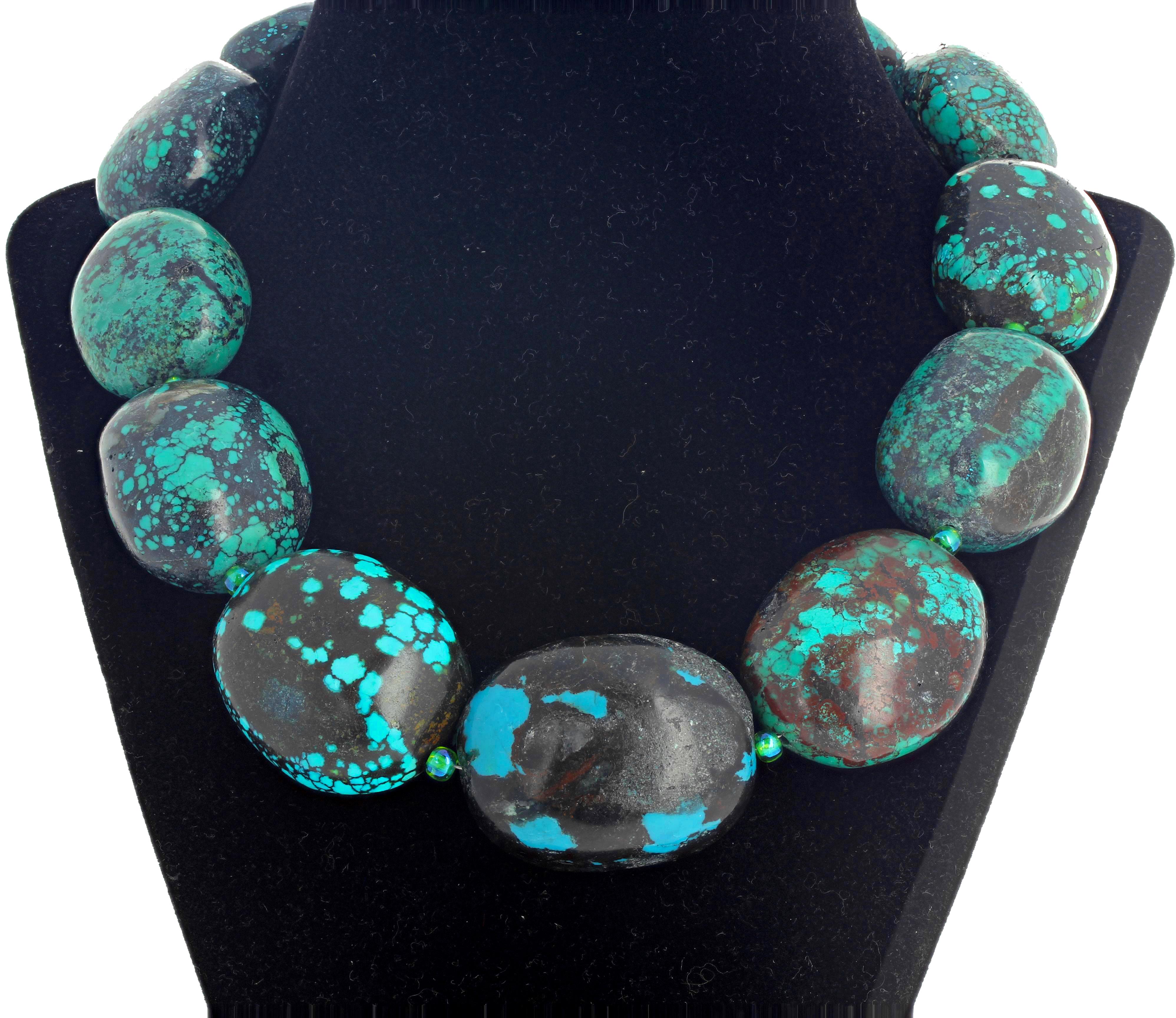 Slightly graduated natural highly polished Turquoise (largest is approximately 40 mm x 30 mm) accented with sparkling bluishgreen Czech nuggets set in this super elegant 18 inch long necklace.  The easy to work clasp is sterling silver inlaid with