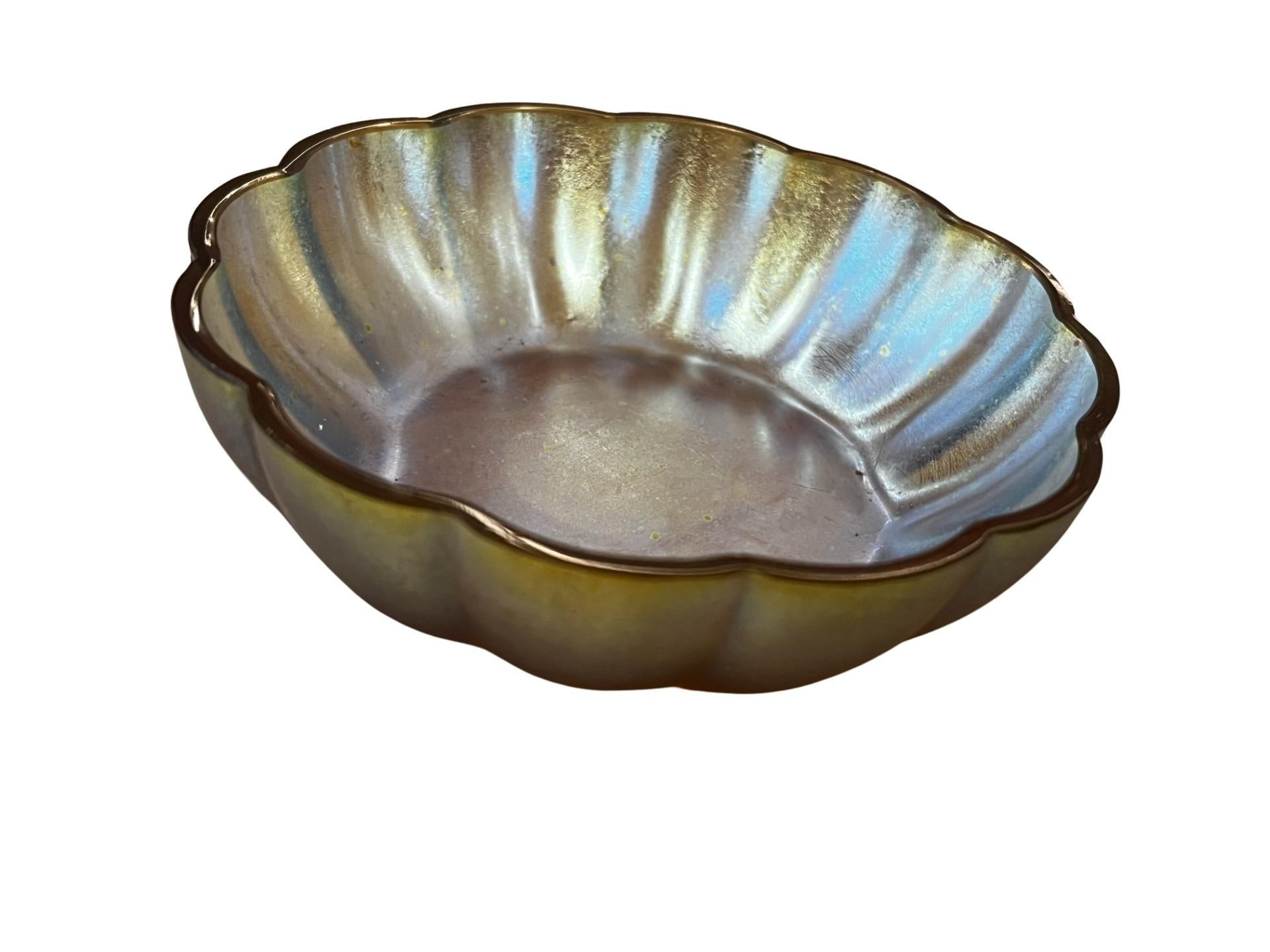 Beautiful iridescent bowl from the famous Württembergische Metallwarenfabrik in Germany, WMF, a very stunning piece from the Art Deco period. This object, called Myra Glas, was developed by WMF in the 1920s. 

The bowl has a round base and a flat