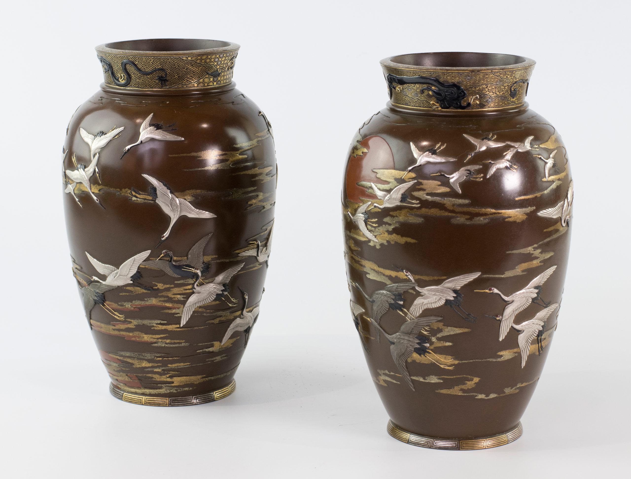 As part of our Japanese works of art collection we are delighted to offer this most unusual pair of Meiji Period 1868-1912, bronze and mixed metal vases, each individual vase depicts a multitude of silver, shibuichi and mixed alloy Manchurian cranes