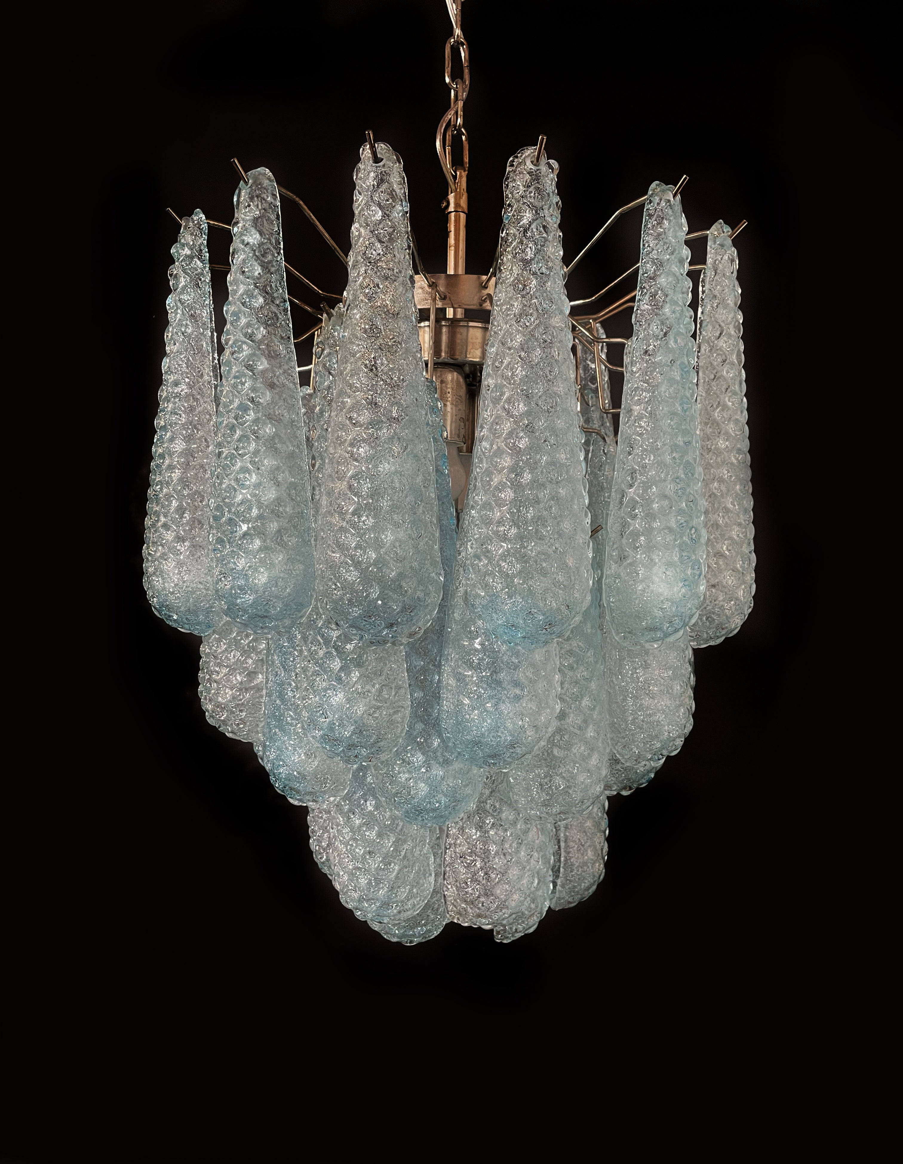 Pair Italian vintage Murano chandeliers made by 41 glass petals (light blue crystal, smooth outside, with powder and then rough inside.) in a chrome frame.
Period: late 20th century
Dimensions: 49,20 inches (125 cm) height with chain; 25,80 inches