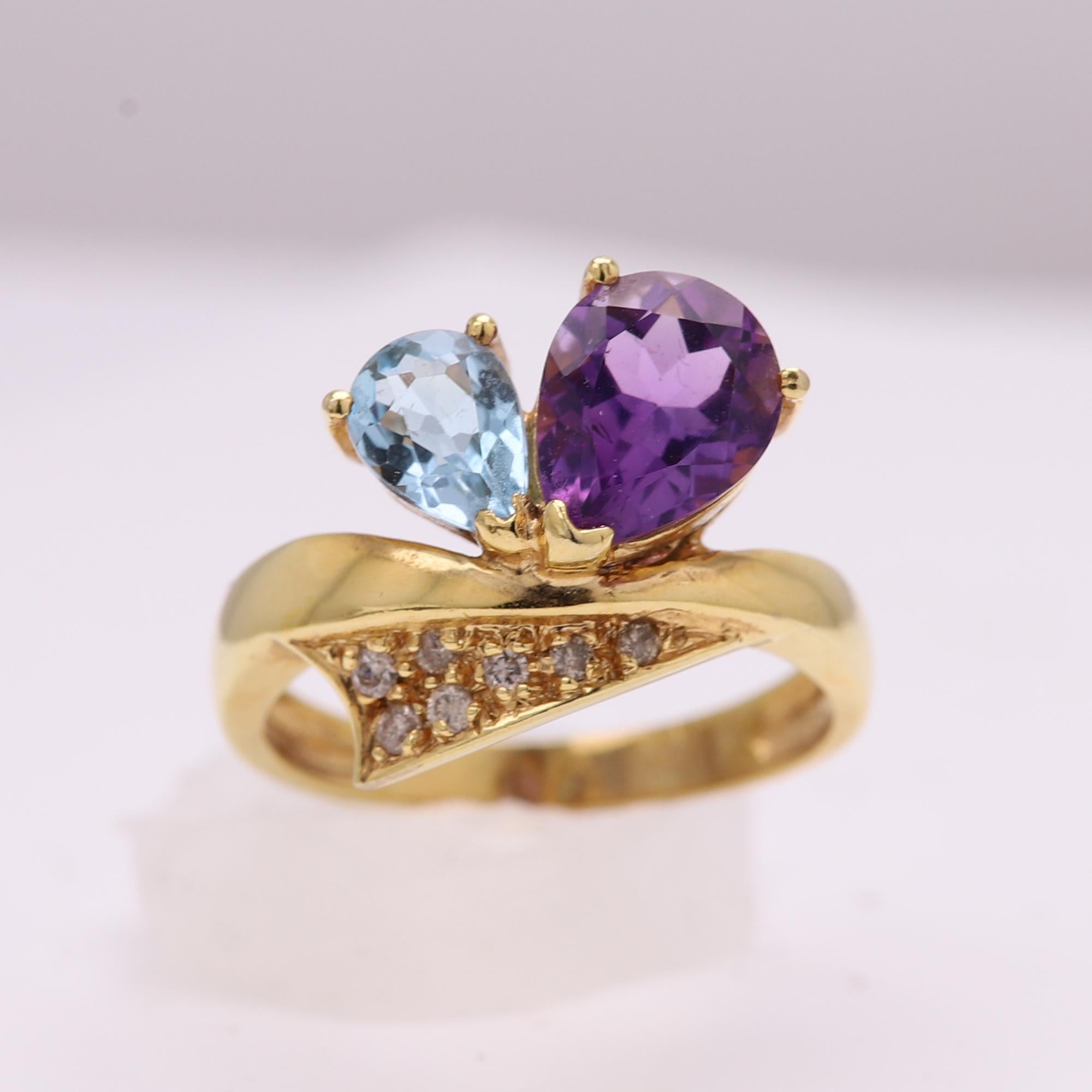 Circa 1950 a vintage cluster pear shape gemstone ring.
Brilliant colors of natural amethyst and blue topaz plus some diamonds.
Pear shape Amethyst size 9x7mm, Blue Topaz 7x5mm.
14k Yellow Gold 3.80 grams
Pre-owned in excellent condition.
Gift Box