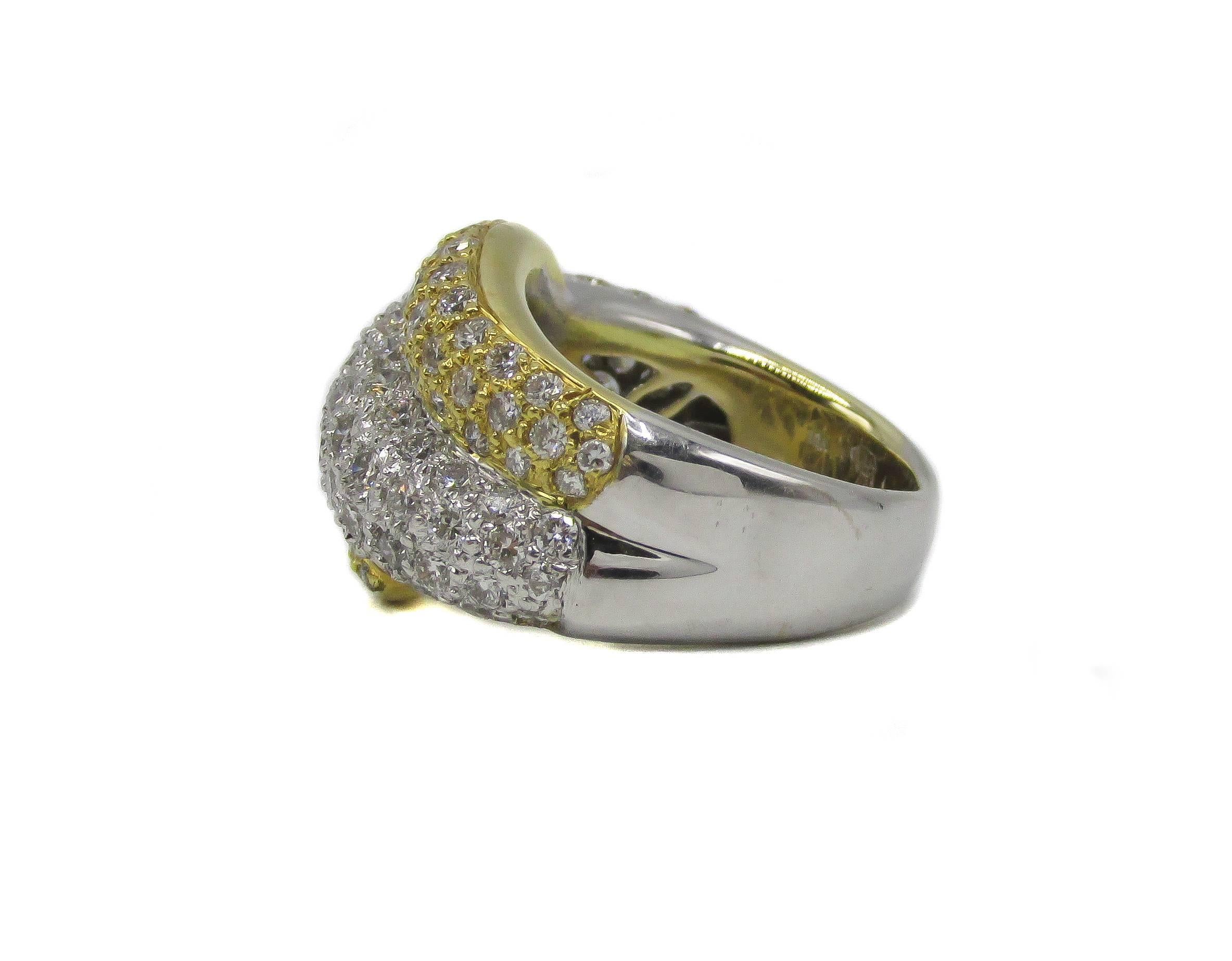 Extremely fashionable and chic 18 karat white and yellow gold diamond ring pave set with bright white and sparkling round brilliant cut diamonds The band is designed of one central white gold section with a yellow gold graduation rounded band coming