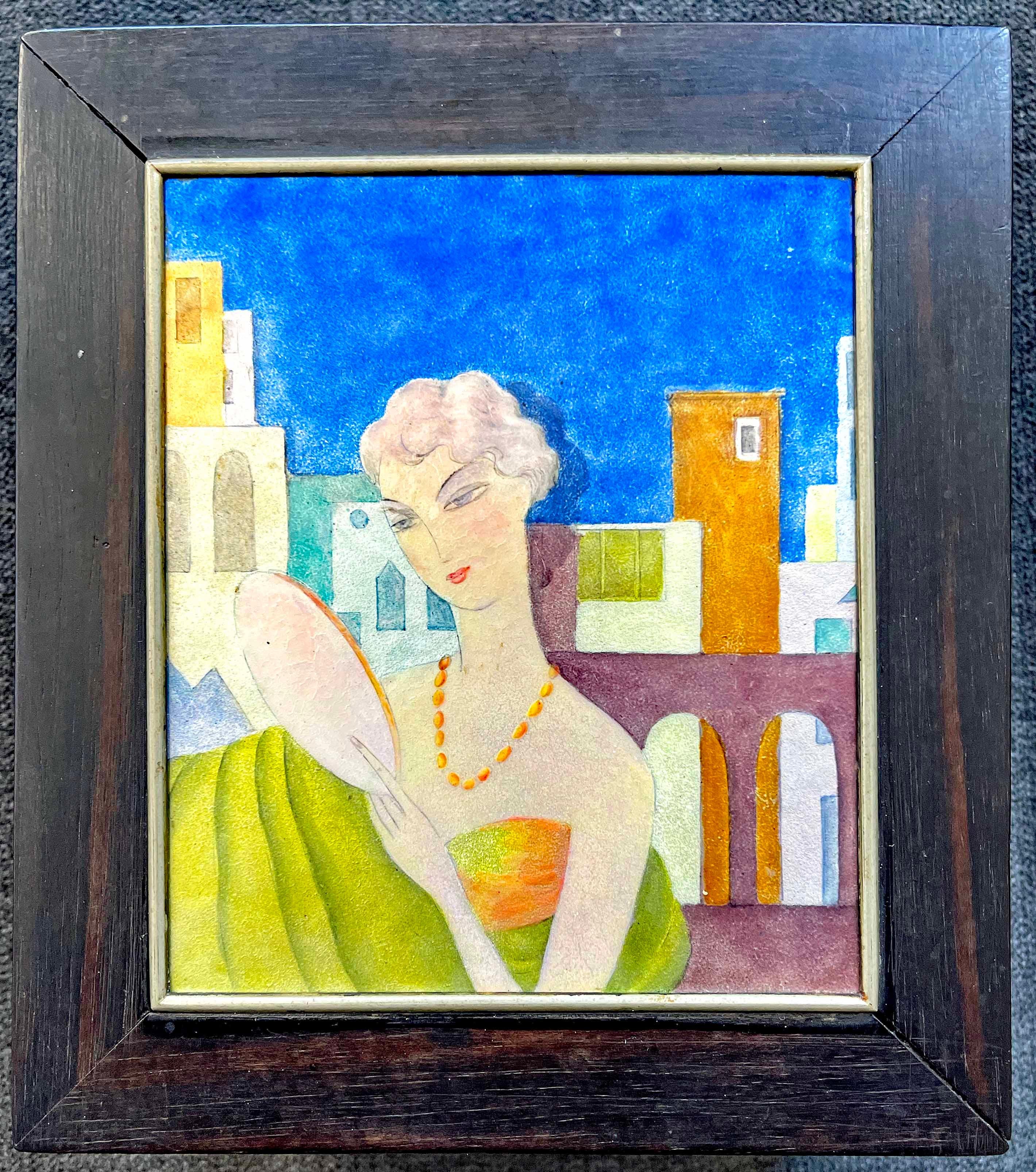 Brilliantly enameled in jewel tones -- sapphire, tourmaline, amethyst and jasper -- this 1920s hardwood box features a glowing scene of a fashionably dressed woman admiring her visage in an oval hand mirror. Her dress is shimmering in tones of