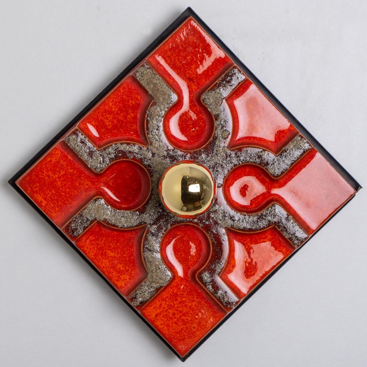 'Fat Lava' style ceramic square wall light with bright red glaze. Manufactured in West-Germany in the 1970's.
The style of the glaze is called 'Fat Lava'. Which means the glaze is thick on some parts, like lava.
A typical way to finish ceramic in