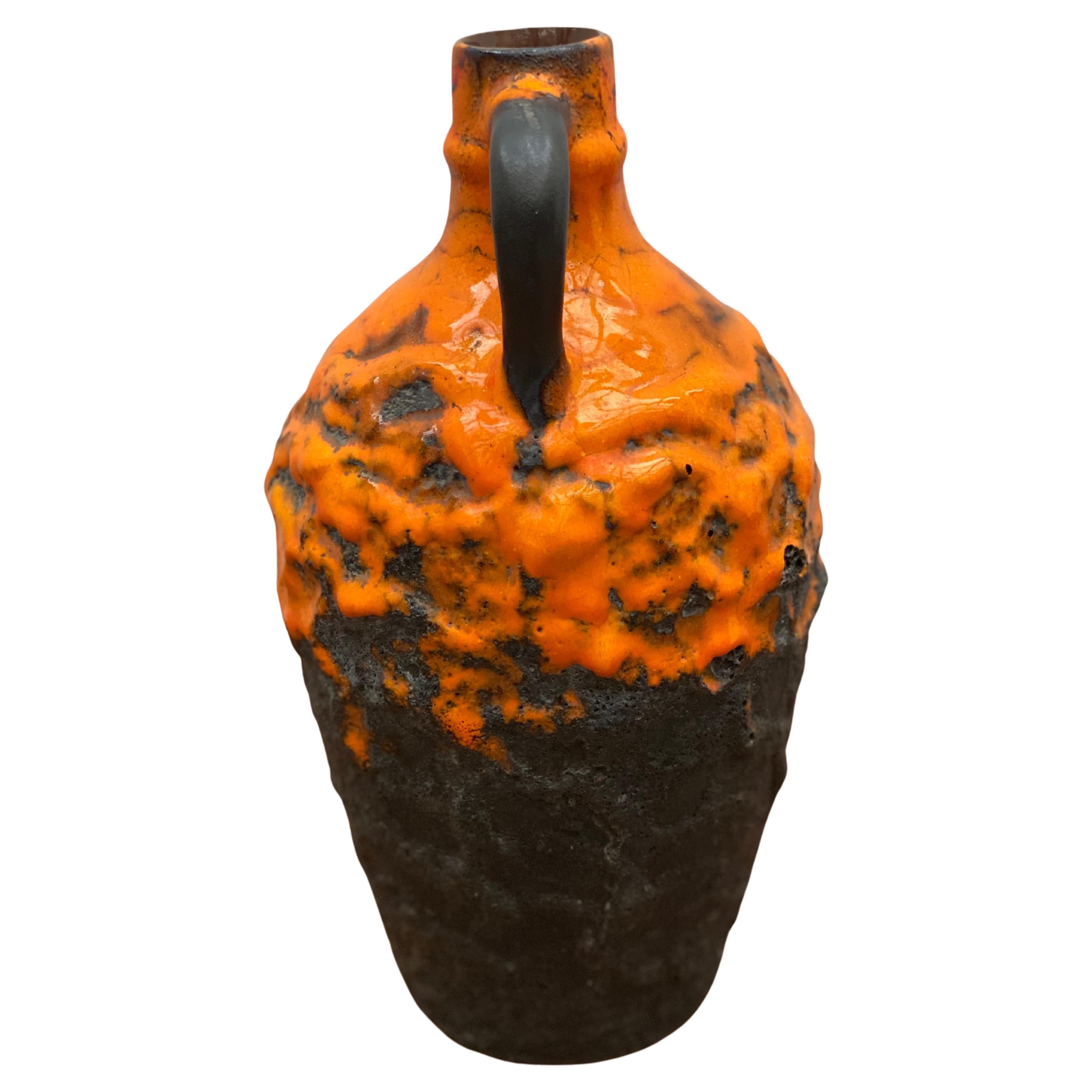 An orange, brown fat lava ceramic vase designed and manufactured in Germany by Carstens in perfect condition signed on the bottom with W. Germany.
The bright Orange color is a must have for your interior.