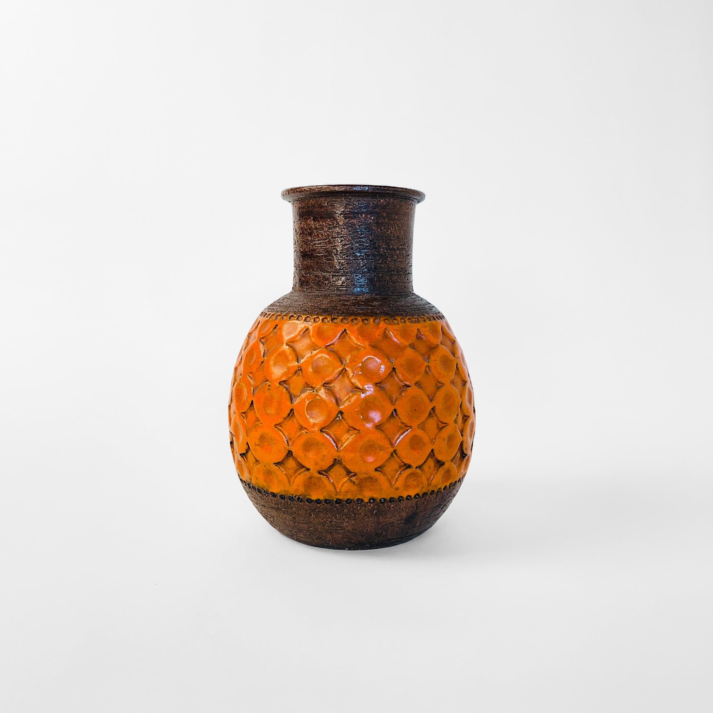 Fat lava style orange vase. Bottom and neck in deep brown textured finish and pattern band in the center, finished in bright orange glaze.