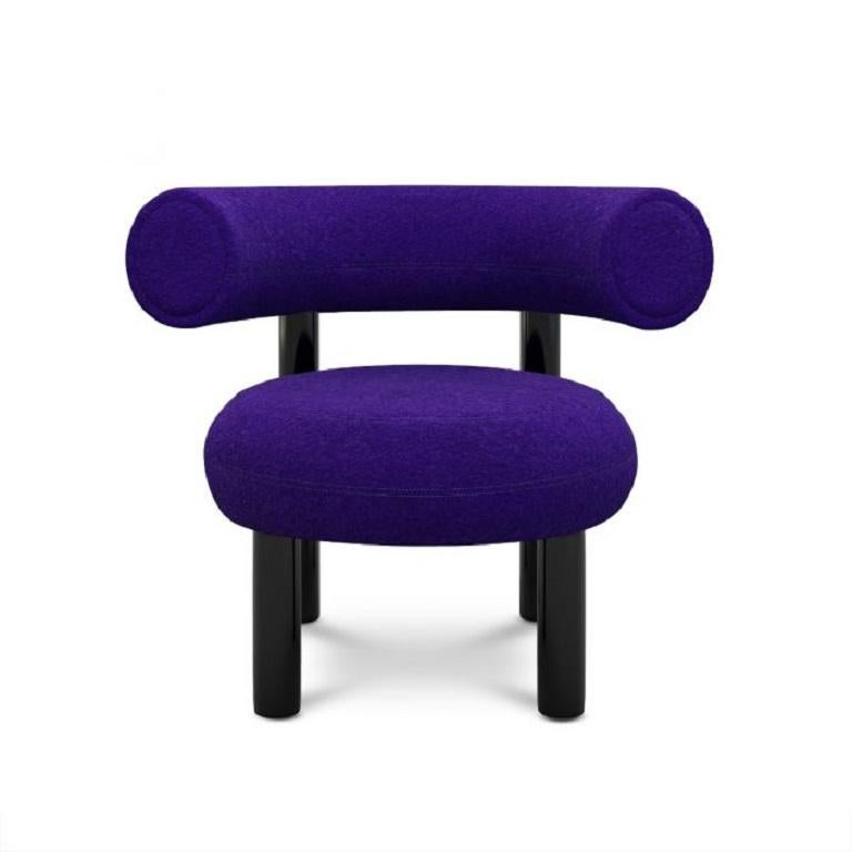 Designed to hug the body and allowing for multiple sitting positions, this lounge chair is upholstered using Kvadrat's purple woolen fabric. Fat is made from moulded foam with a metal leg launching in high gloss black lacquer and made to order