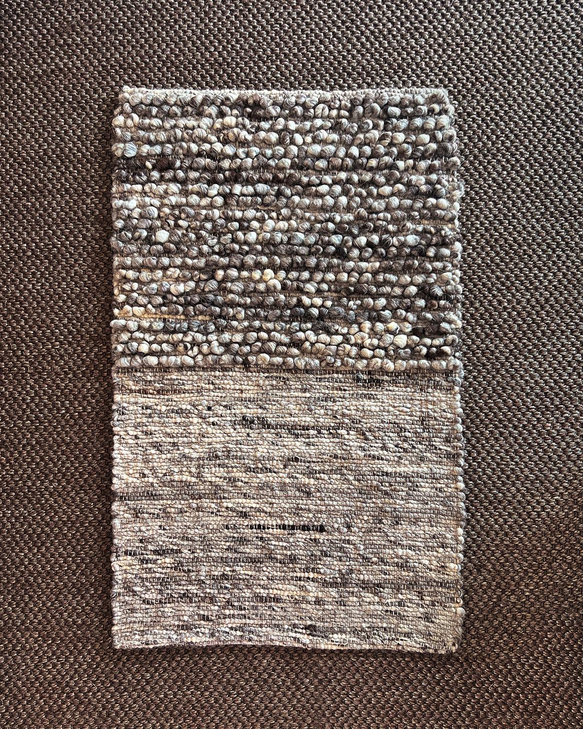 A cozy textured wool rug to warm up your home. Elevate your living space with the Fatima Nubby Wool Area Rug. Handmade with 100% wool from Portugal, its unique nubby texture adds an organic modern touch to any room. Woven with wool in stylish shades
