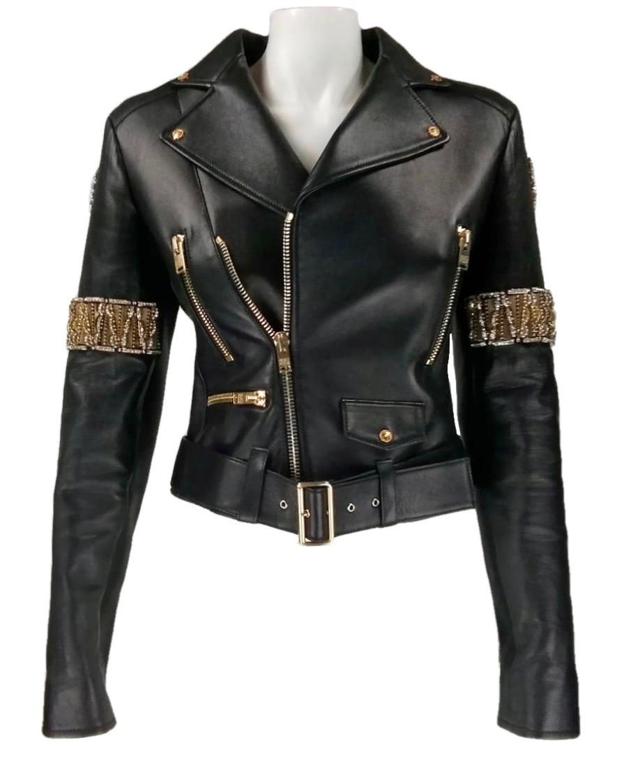 FAUSTO PUGLISI
Black leather biker jacket with  large golden studs and crystals
100%  Leather
100%  Silk lining
100% Polyurethane padding
Size IT40
Made in Italy
Flat measures:
Length cm. 53
Shoulders cm. 39
Bust cm. 41
Waist cm. 37
Sleeve cm.