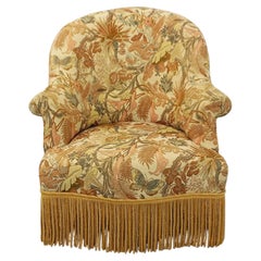 Fauteuil style crapaud vintage en tissu floral à franges des années 50 60