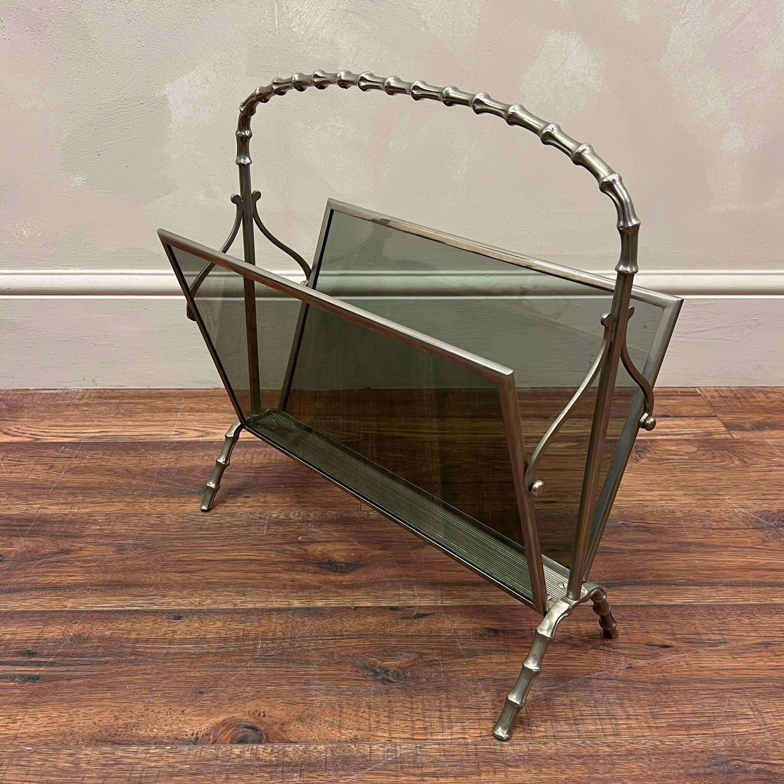 A faux bamboo magazine rack by Maison Baguès .
Original smoked glass sides in a polished chrome frame.
A very stylish and rare example. 

France, circa 1940.

Height - 47 cm
width  - 44.5 cm
Depth - 21 cm 

We are happy to work with you with your