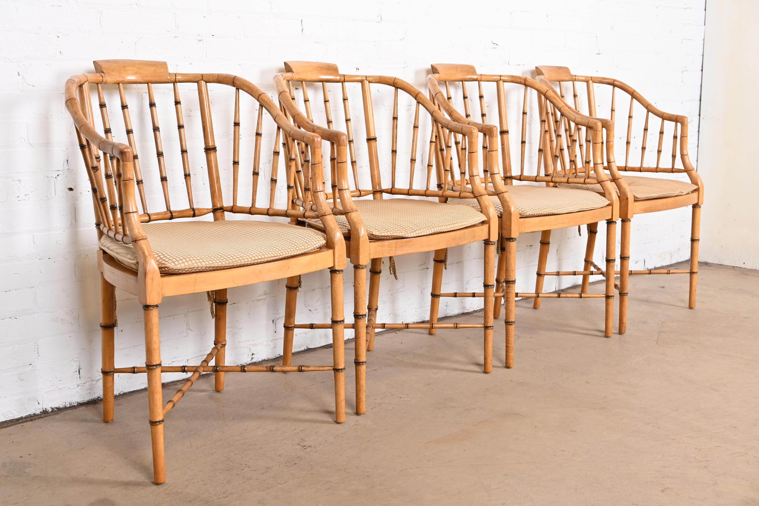 A gorgeous set of four faux bamboo Regency style armchairs

In the manner of Baker Furniture

USA, circa 1960s

Walnut bamboo form frames, with cane seats, and removable upholstered cushions.

Measures: 21.5