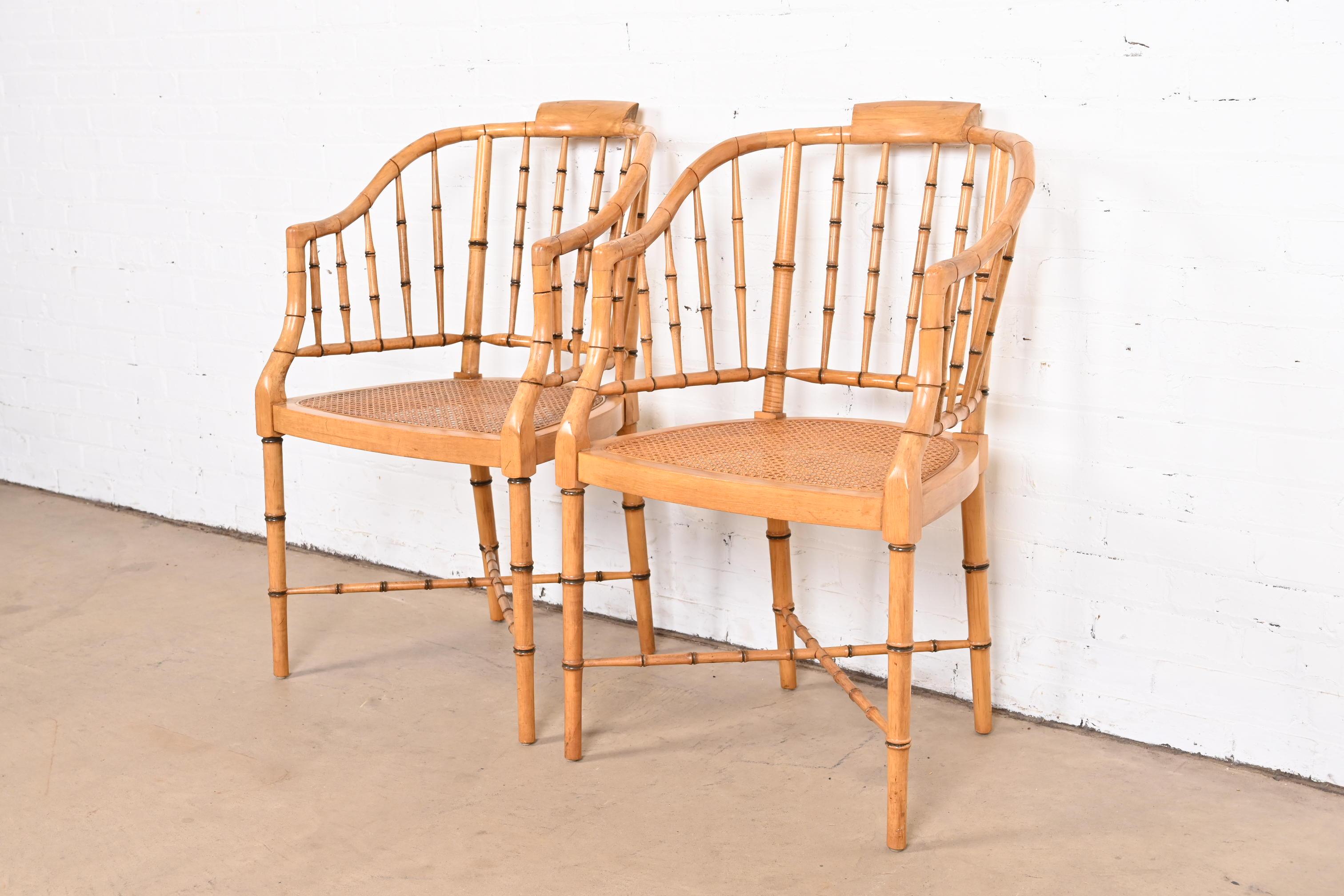 A gorgeous pair of faux bamboo Regency style armchairs, club chairs, or tub chairs

Attributed to Baker Furniture

USA, circa 1960s

Bamboo form hardwood frames, with cane seats, and removable upholstered seat cushions.

Measures: 21.5