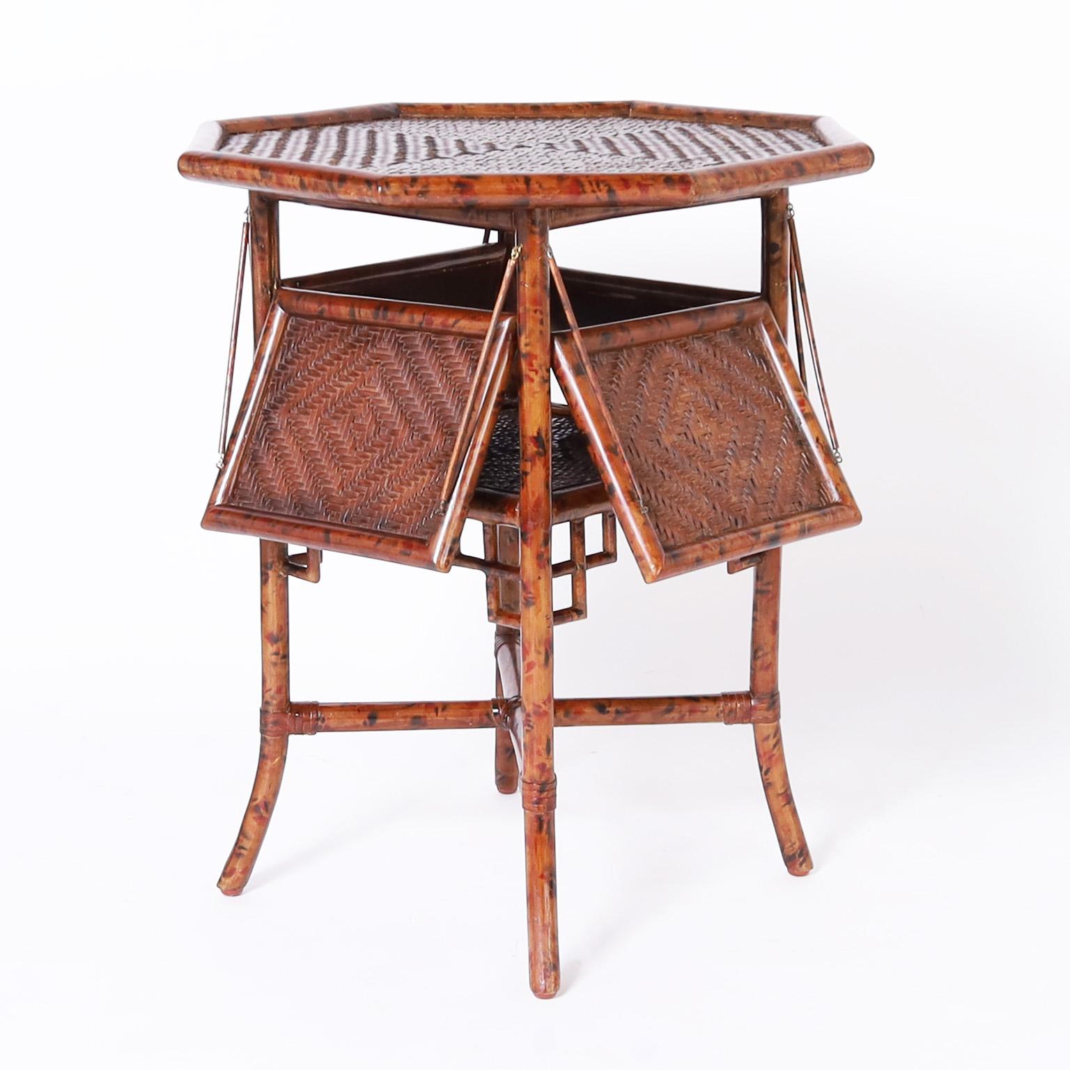 Handsome octagon form table crafted with faux bamboo having a faux tortoise finish and herringbone woven grasscloth on top and on the foldout plateaus. The base has Asian style brackets, cross stretchers, and splayed legs. 

Width with open: