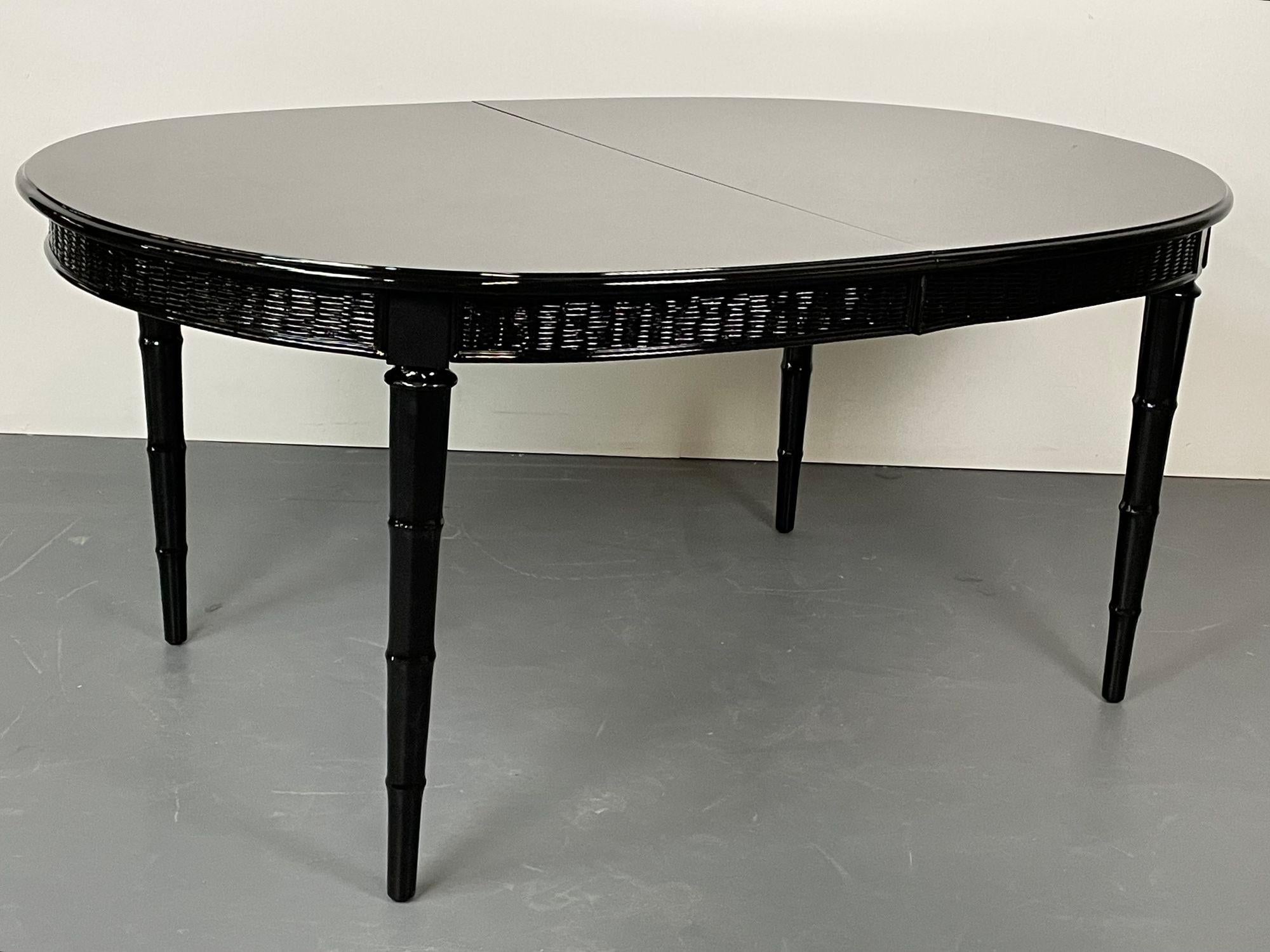 Faux Bamboo and wicker dining table having two leaves fully refinished in a black lacquer by American of Martinsville

A set of bamboo style table legs supporting a finely ebonized table top with a wicker apron. The whole expanding with two 16