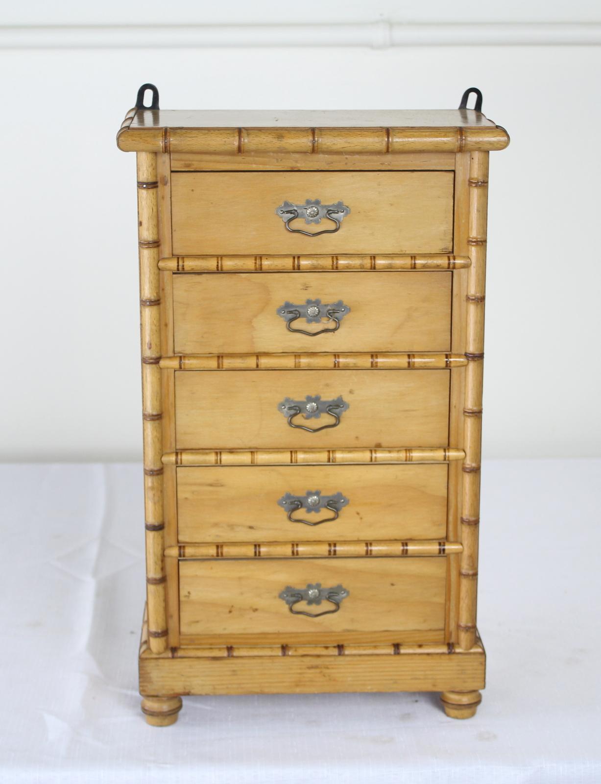 A charming example of 19th century apprentice miniatures, complete with original wire drawer pulls. The interiors of the drawers are quite clean. The piece came to us with metal brackets for hanging, and we have left them in place. However, they can