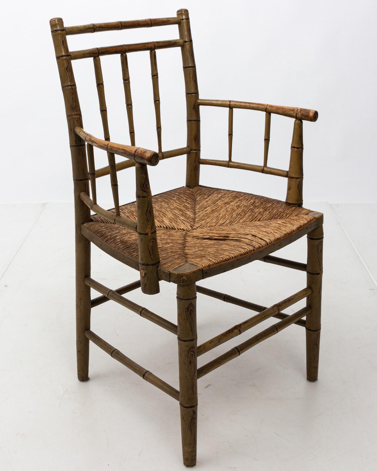 Aux bamboo painted armchair with woven rush seat and square, slat back. Please note of wear consistent with age including paint and finish loss.