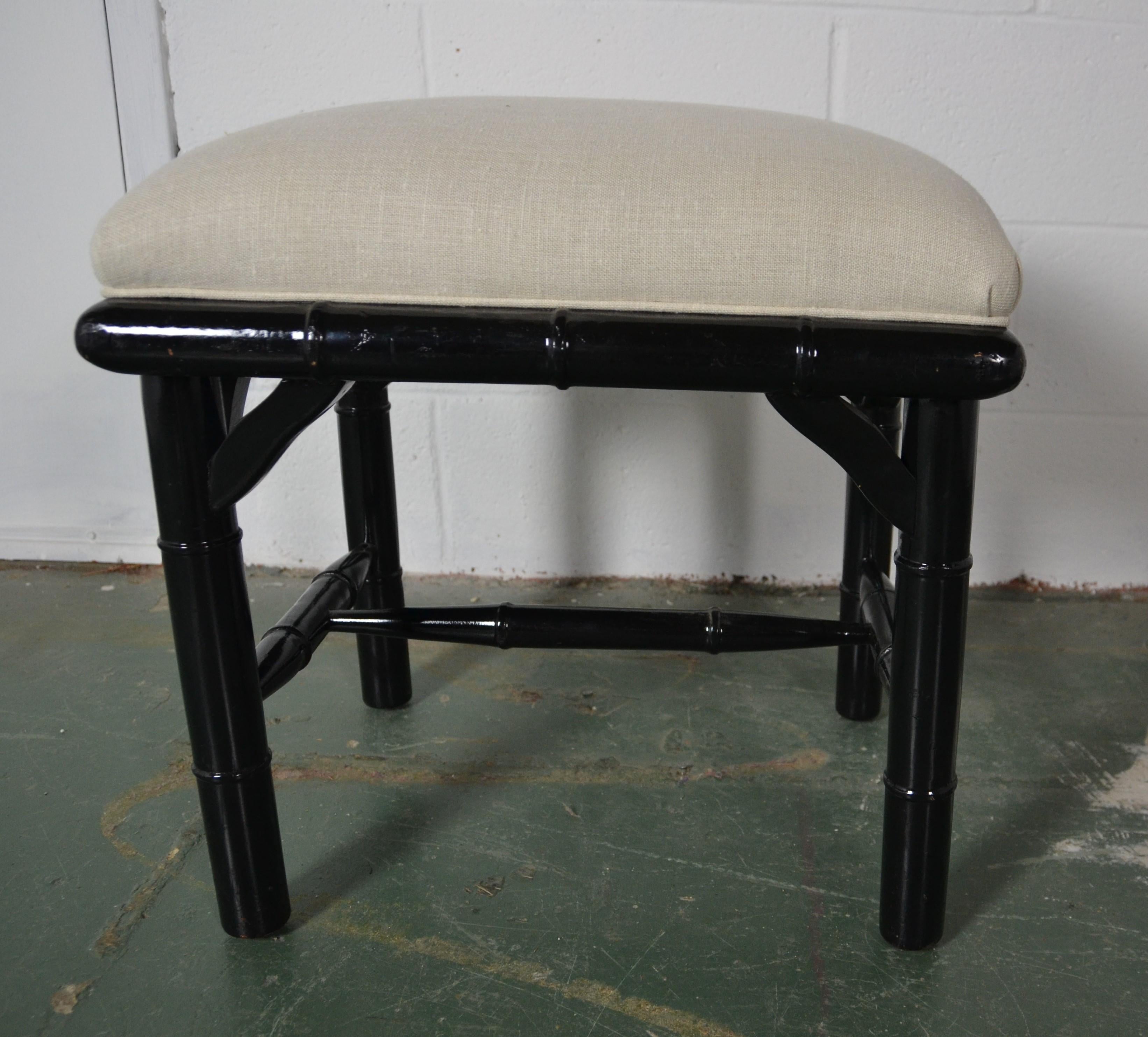 Black color faux-bamboo bench. Upholstered in linen.