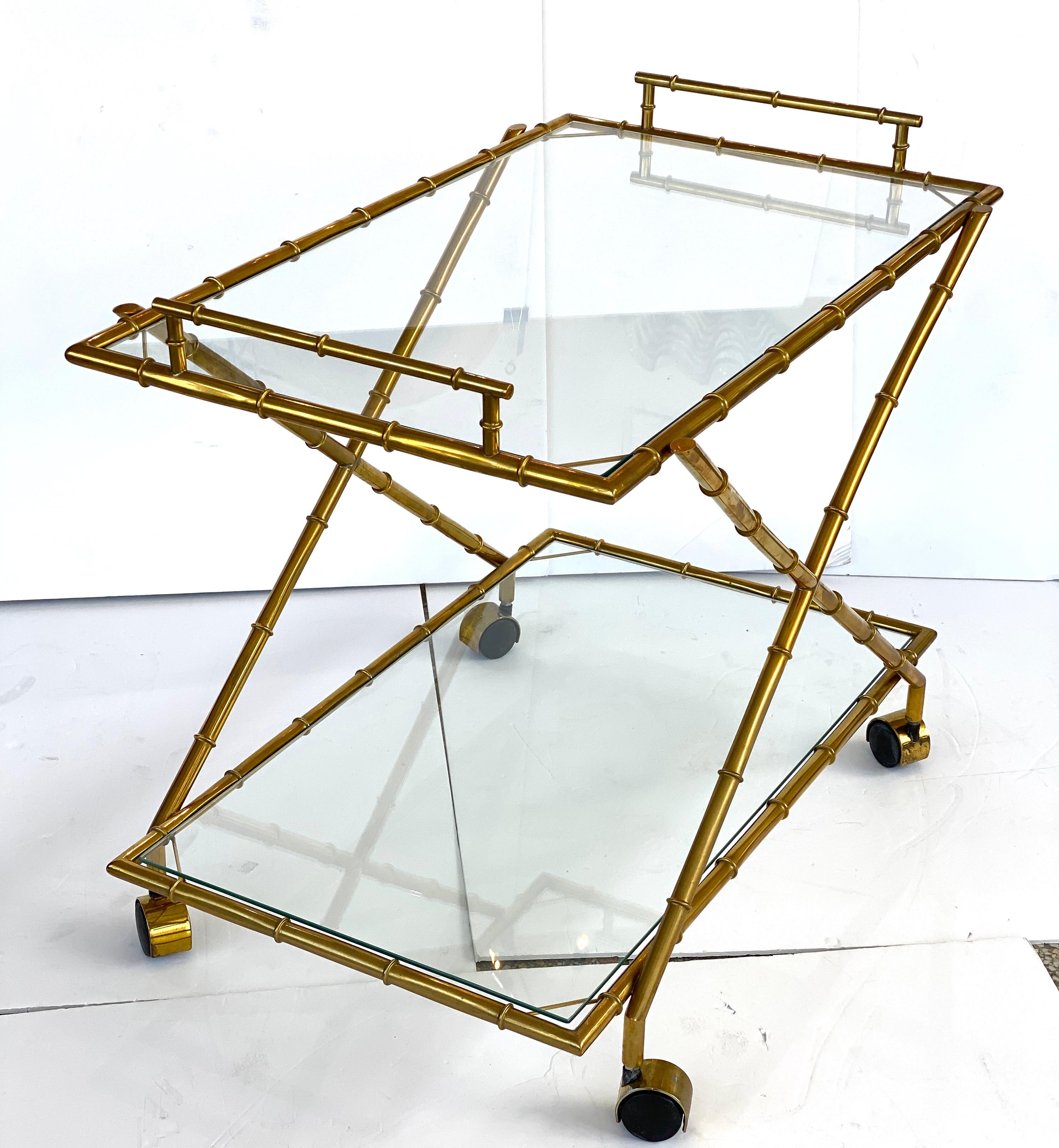 This stylish Hollywood Regency inspired bar cart with its faux bamboo frame and clear glass shelves will make a subtle statement for you barware.