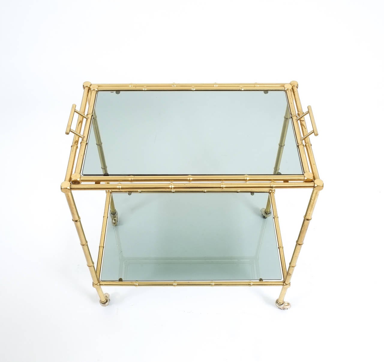 Faux bamboo brass bar cart with removable glass tray, France, circa 1960

Elegant midcentury liquor or bar cart table from France in the tradition of Maison Bagues with a removable glass tray and abstracted faux bamboo brass hardware. The glass is