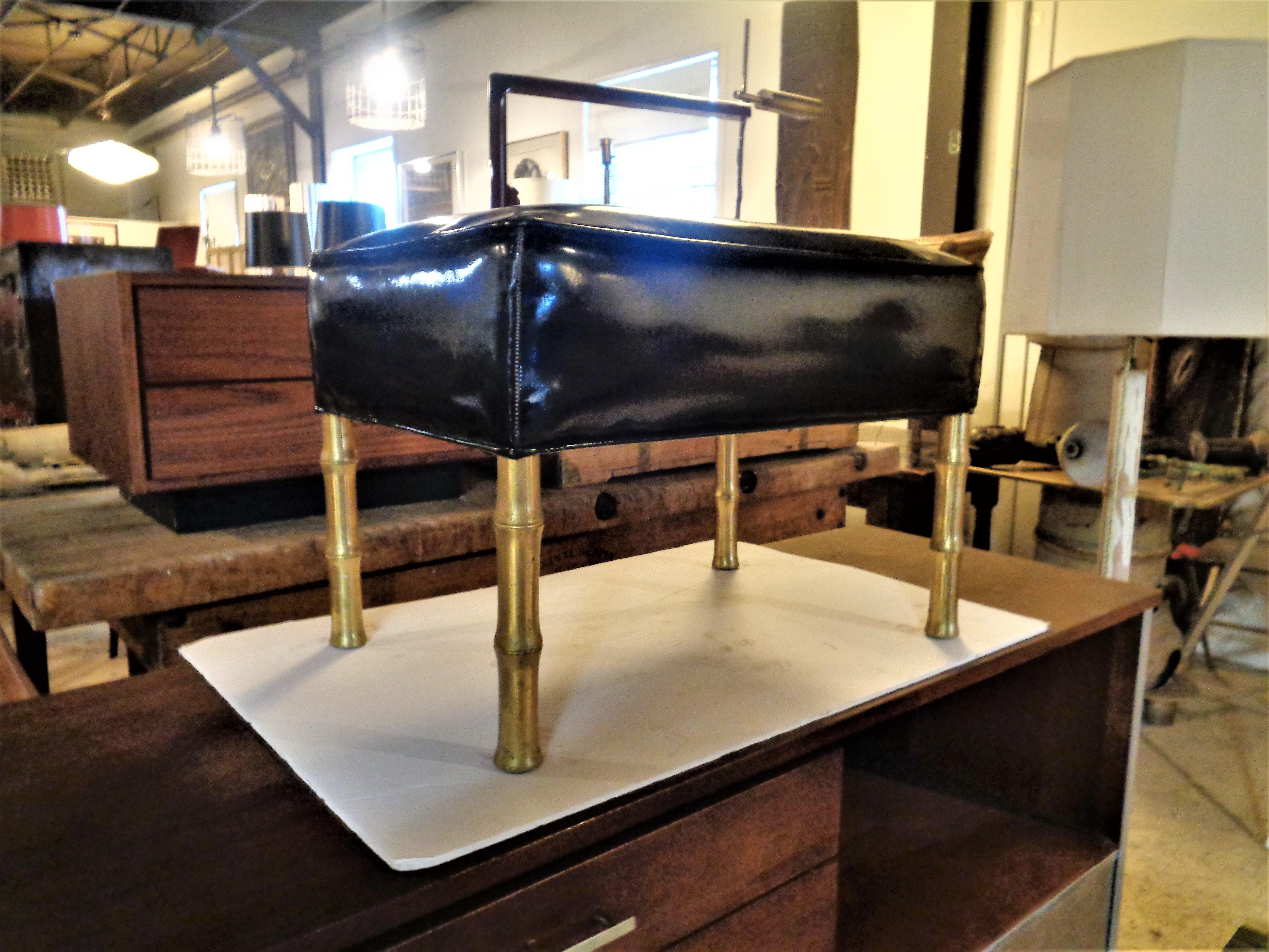 Unusual faux bamboo leg golden brass bronze stool / ottoman with original gloss black patent vinyl leather upholstery. Circa 1960. Look at all pictures and read condition report in comment  section.